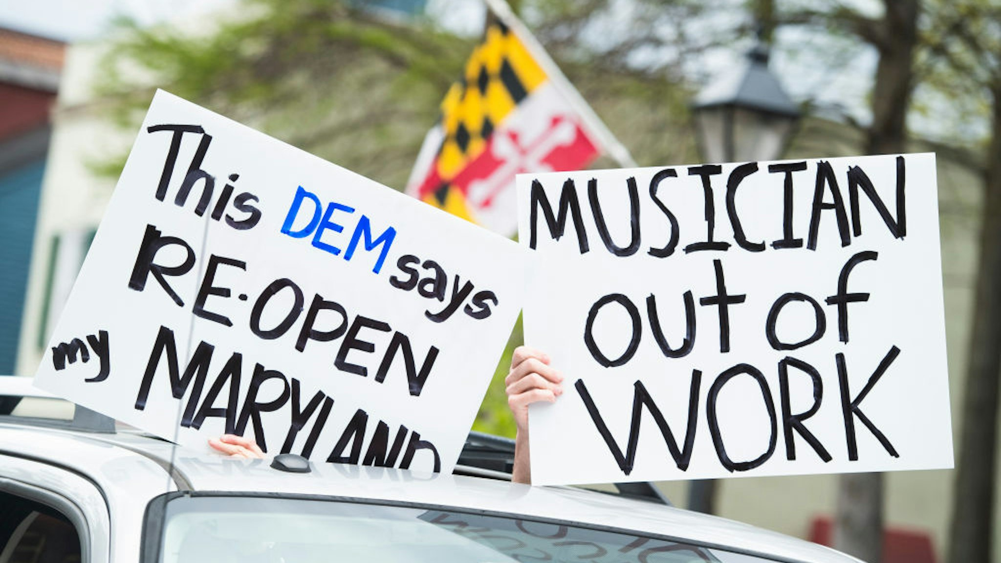 Demonstrators demand that Gov. Larry Hogan (R) lift restrictions that have closed certain businesses in Maryland since the coronavirus outbreak on Church Circle in Annapolis, Md., on Saturday, April 18, 2020. The event titled Operation Gridlock Annapolis was hosted by the Patriot Picket and Reopen Maryland. (Photo By Tom Williams/CQ-Roll Call, Inc via Getty Images)