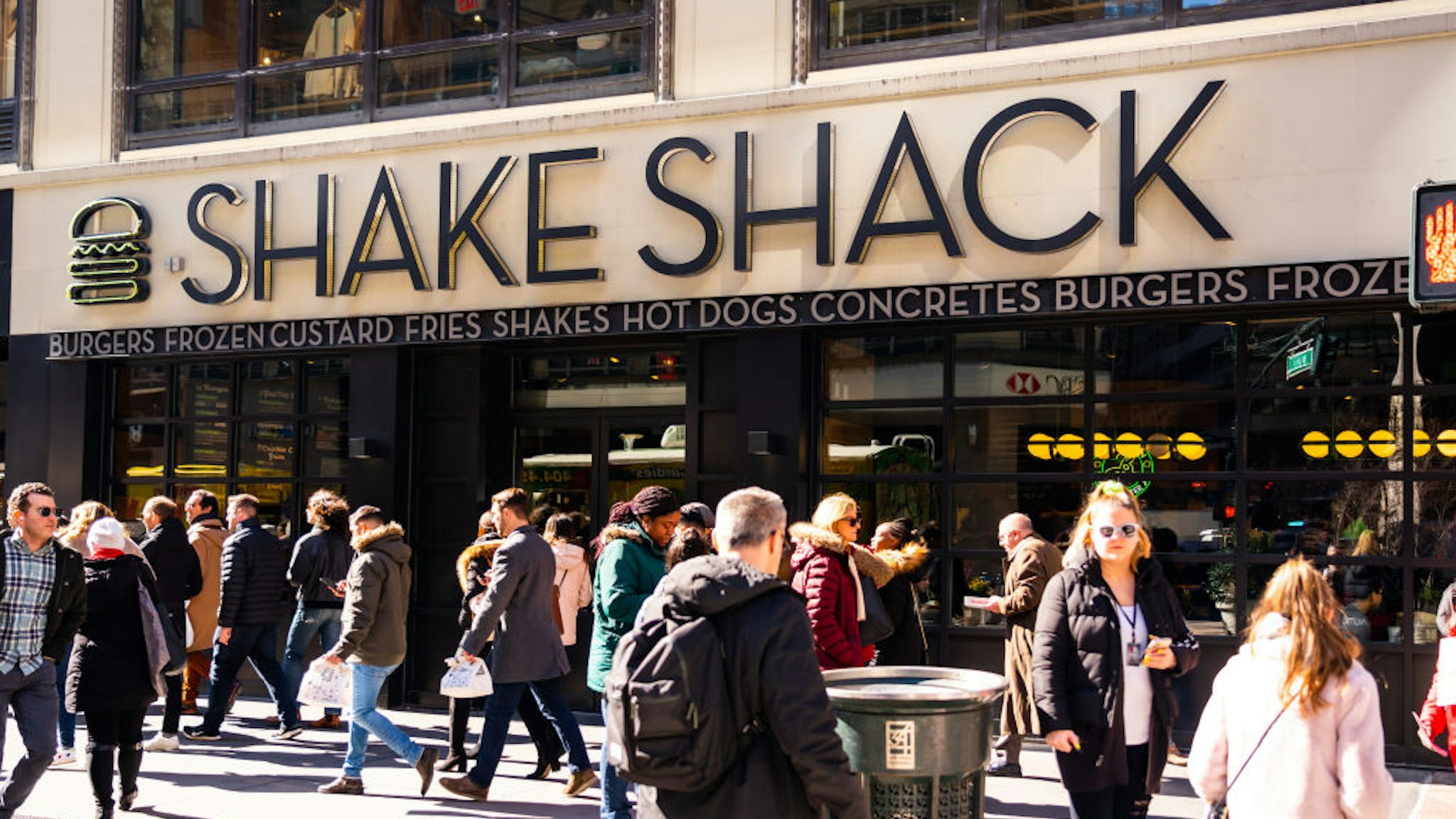 NEW YORK CITY, UNITED STATES - 2020/02/20: Pedestrians walk past an American fast casual restaurant chain, Shake Shack store in New York City. (Photo Illustration by Alex Tai/SOPA Images/LightRocket via Getty Images)