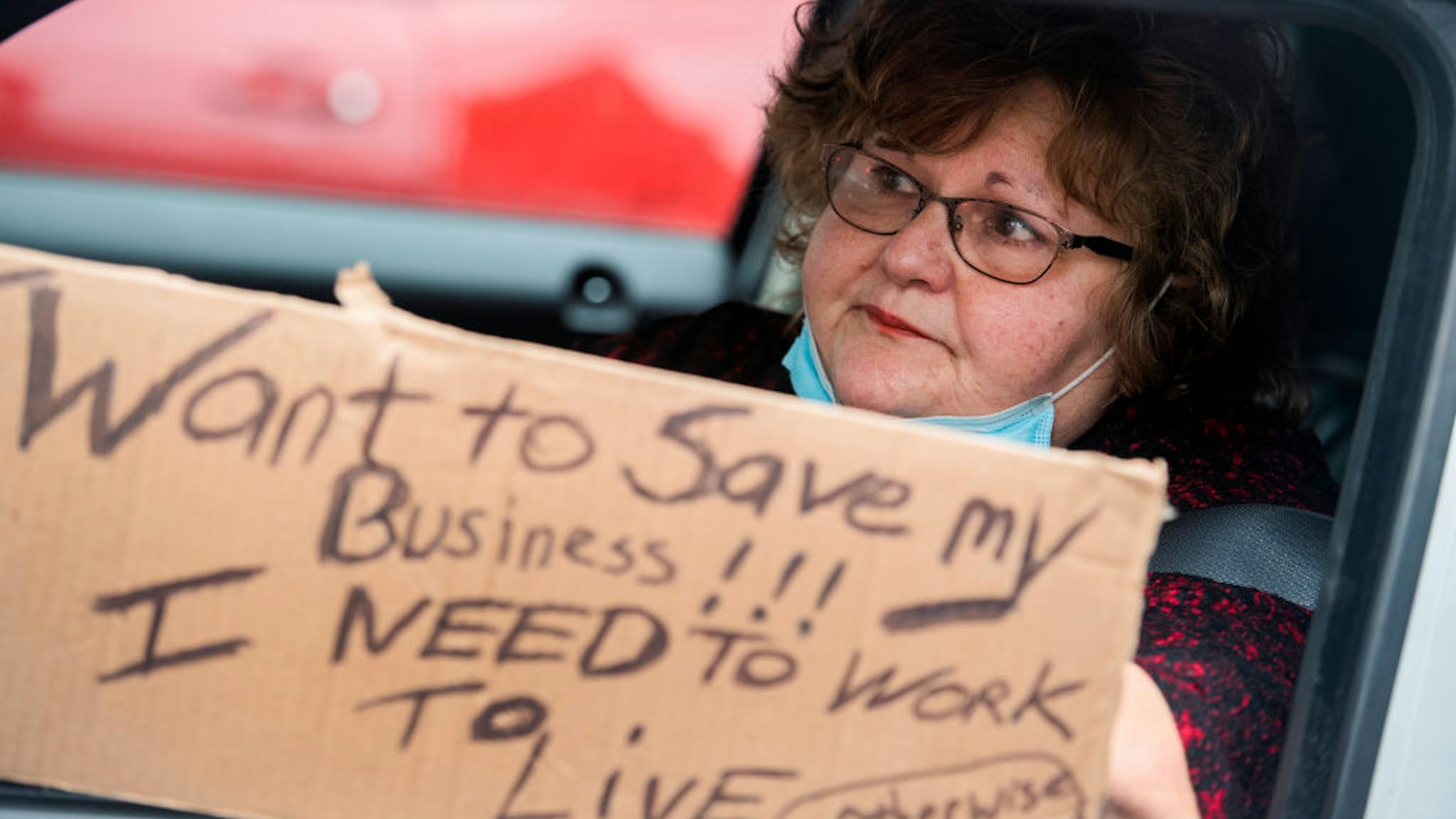 UNITED STATES - APRIL 18: Dolores Garrity, 61, a hair salon owner, demands that Gov. Larry Hogan (R) lift restrictions that have closed certain businesses in Maryland since the coronavirus outbreak on Church Circle in Annapolis, Md., on Saturday, April 18, 2020. The event titled Operation Gridlock Annapolis was hosted by the Patriot Picket and Reopen Maryland. (Photo By Tom Williams/CQ-Roll Call, Inc via Getty Images)