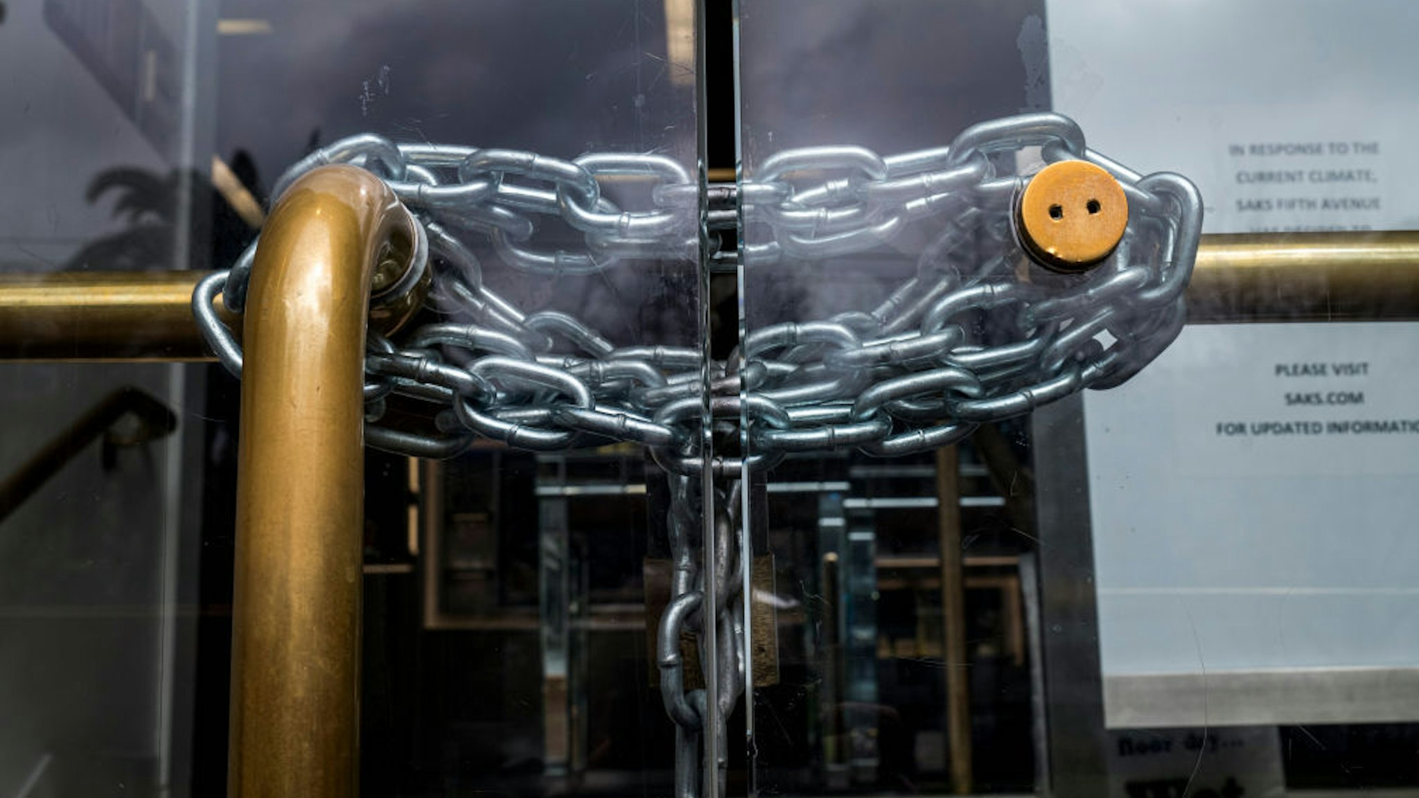 A chain is wrapped around the door of a Saks Fifth Avenue Inc. store in San Francisco, California, U.S., on Tuesday, March 24, 2020. Governors from coast to coast Friday told Americans not to leave home except for dire circumstances and ordered nonessential business to shut their doors. Photographer: David Paul Morris/Bloomberg