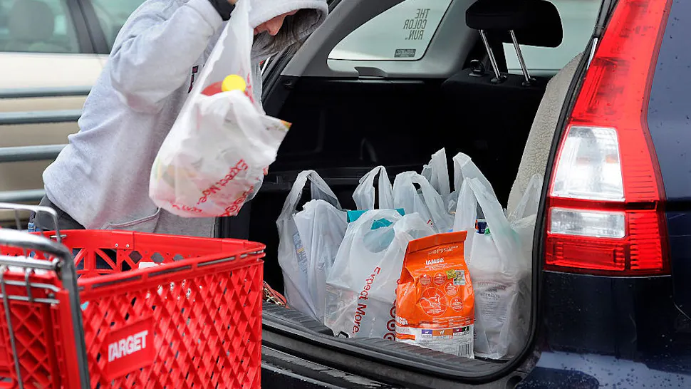 Target Bags Melody Bertrand of Durham fills her car with products from Target in plastic bags. She said she is a dedicated recycler but forgot to bring her reusable bags to Target. "I always recycle the plastic bags by bringing them back and putting them into the plastic bag recycled container inside Target," she said. "They should let people take the merchandise to their cars and put the bags back into the cart to be recycled by the store. The store should make the bags bigger and put more into them, she added." (Photo by Gordon Chibroski/Staff Photographer)