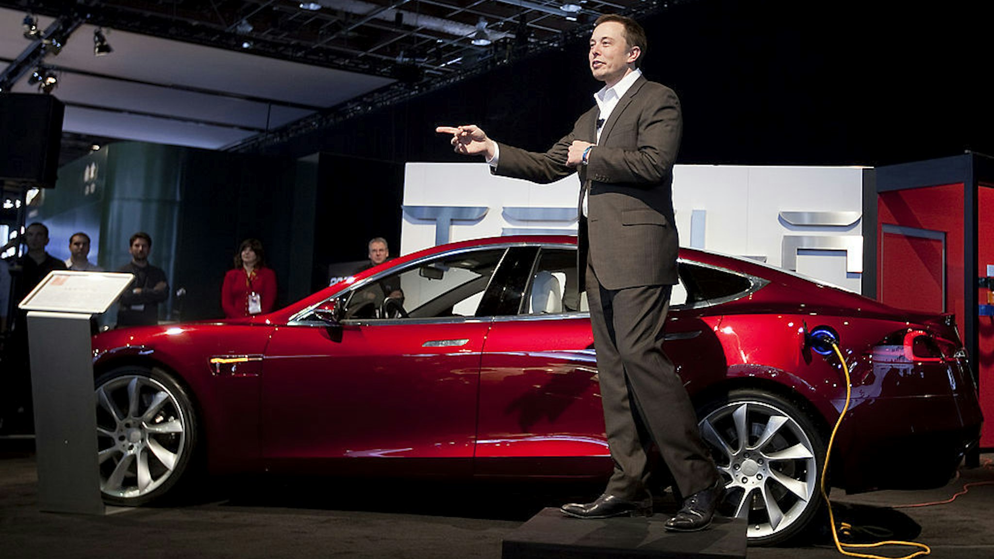 Elon Musk, chairman and chief executive officer of Tesla Motors Inc., speaks in front of a Tesla Model S electric car on day two of the 2010 North American International Auto Show in Detroit, Michigan, U.S., on Tuesday, Jan. 12, 2010. The 2010 Detroit auto show runs through January 24 and features 60 new vehicle premieres. Photographer: Daniel Acker/Bloomberg via Getty Images