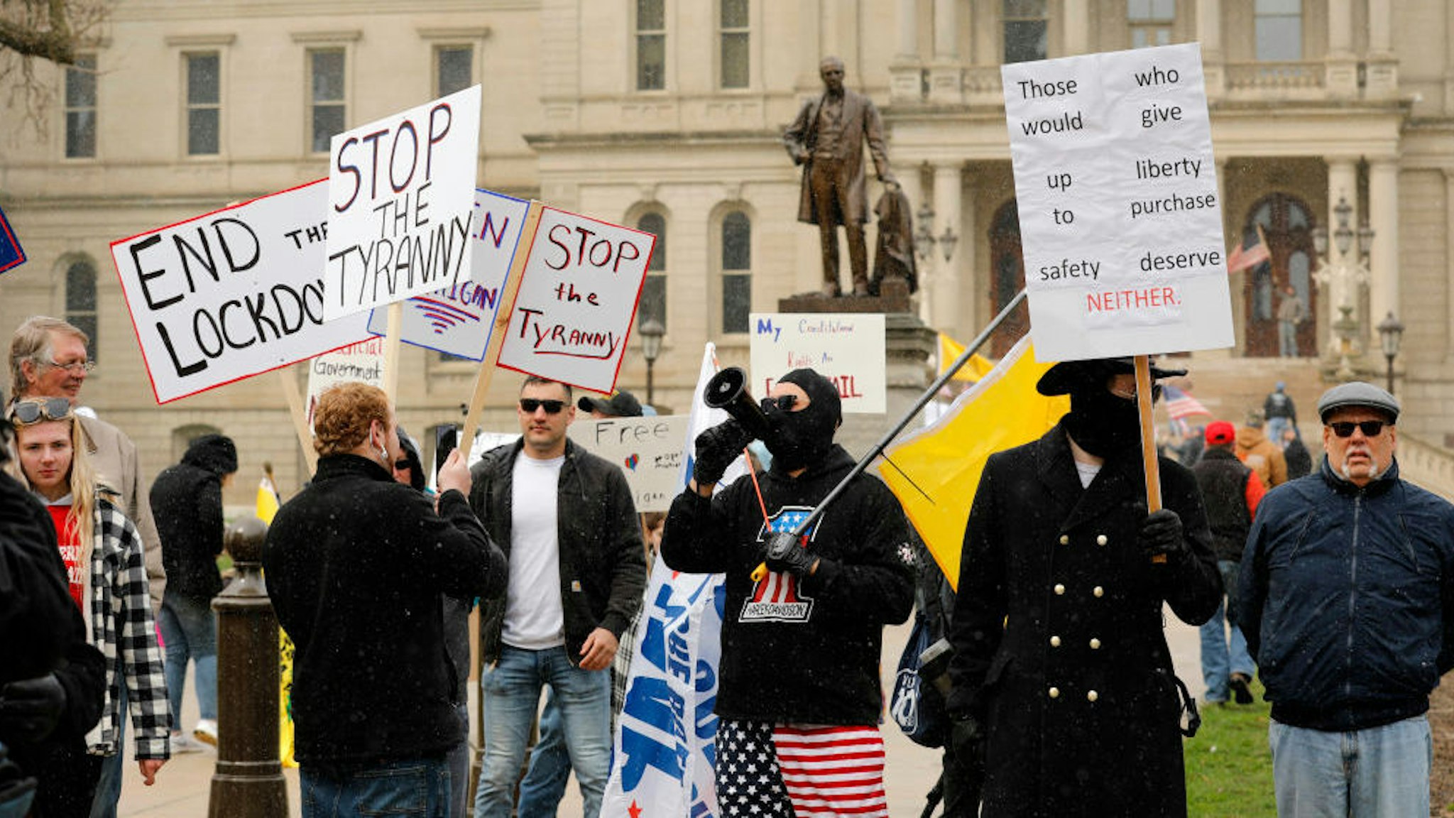 A protest organized by "Michiganders Against Excessive Quarantine" gathers around the Michigan State Capitol in Lansing, Michigan on April 15, 2020. - The group is upset with Michigan Governor Gretchen Whitmer's(D-MI) expanded the states stay-at-home order to contain the spread of the coronavirus. (Photo by JEFF KOWALSKY / AFP) (Photo by JEFF KOWALSKY/AFP via Getty Images)