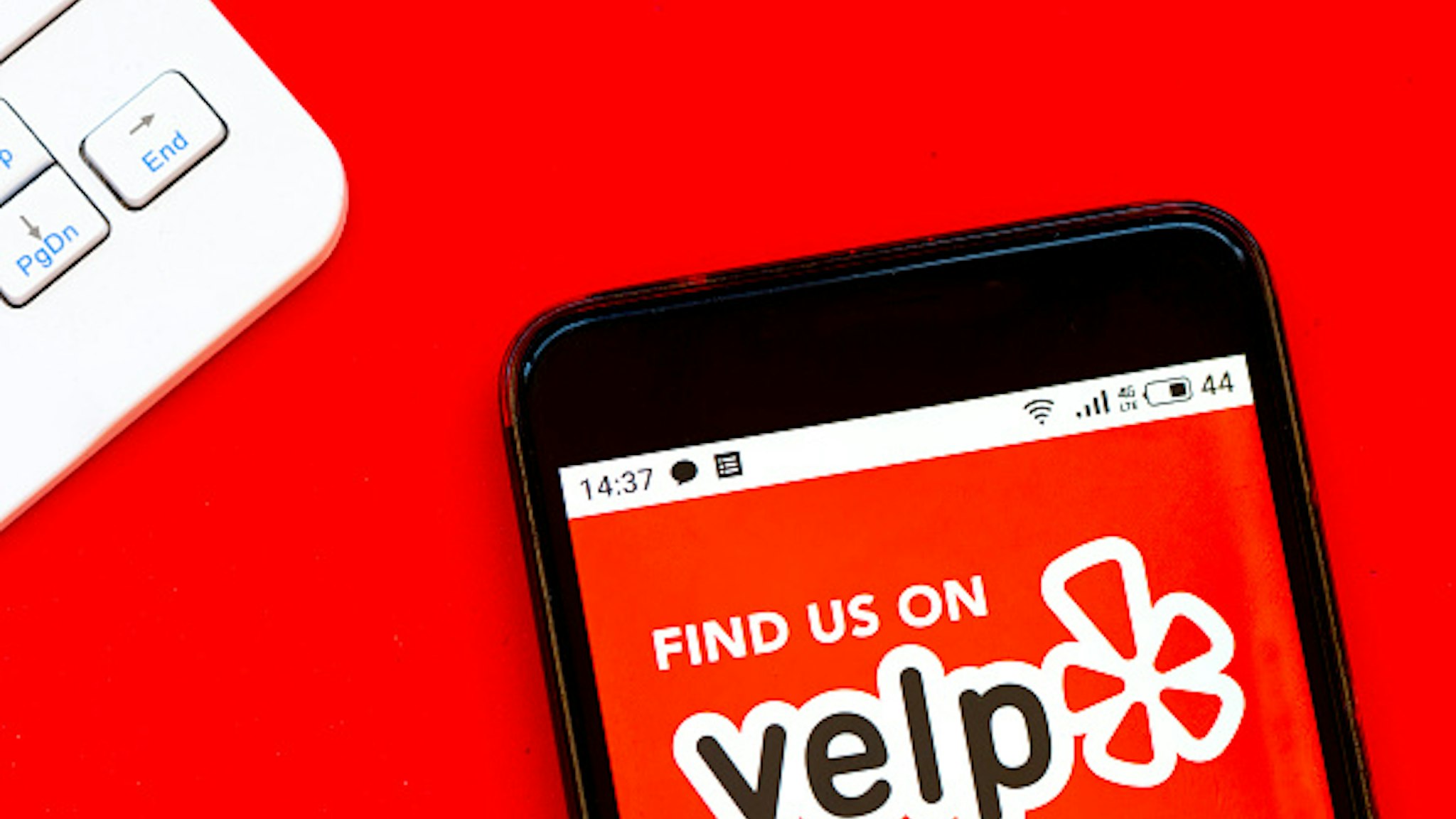 UKRAINE - 2020/04/07: In this photo illustration a Yelp logo seen displayed on a smartphone.
