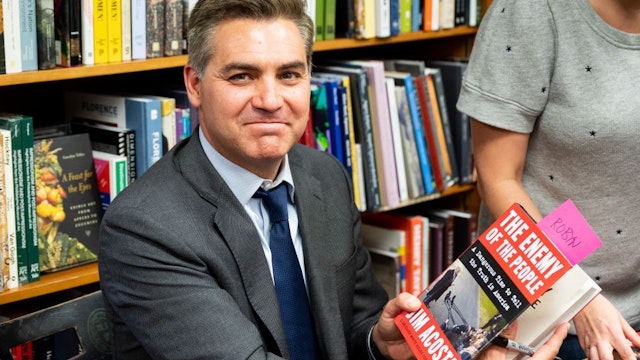 WASHINGTON, D C , UNITED STATES - 2019/06/18: Jim Acosta holds his book "The Enemy of the People: A Dangerous Time to Tell the Truth in America" at the Politics and Prose bookstore in Washington, DC. (Photo by