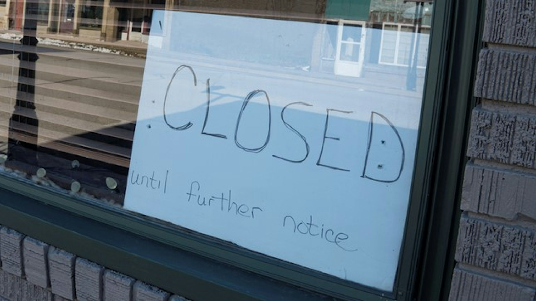 Closed Until Further Notice Sign in Small Business Window