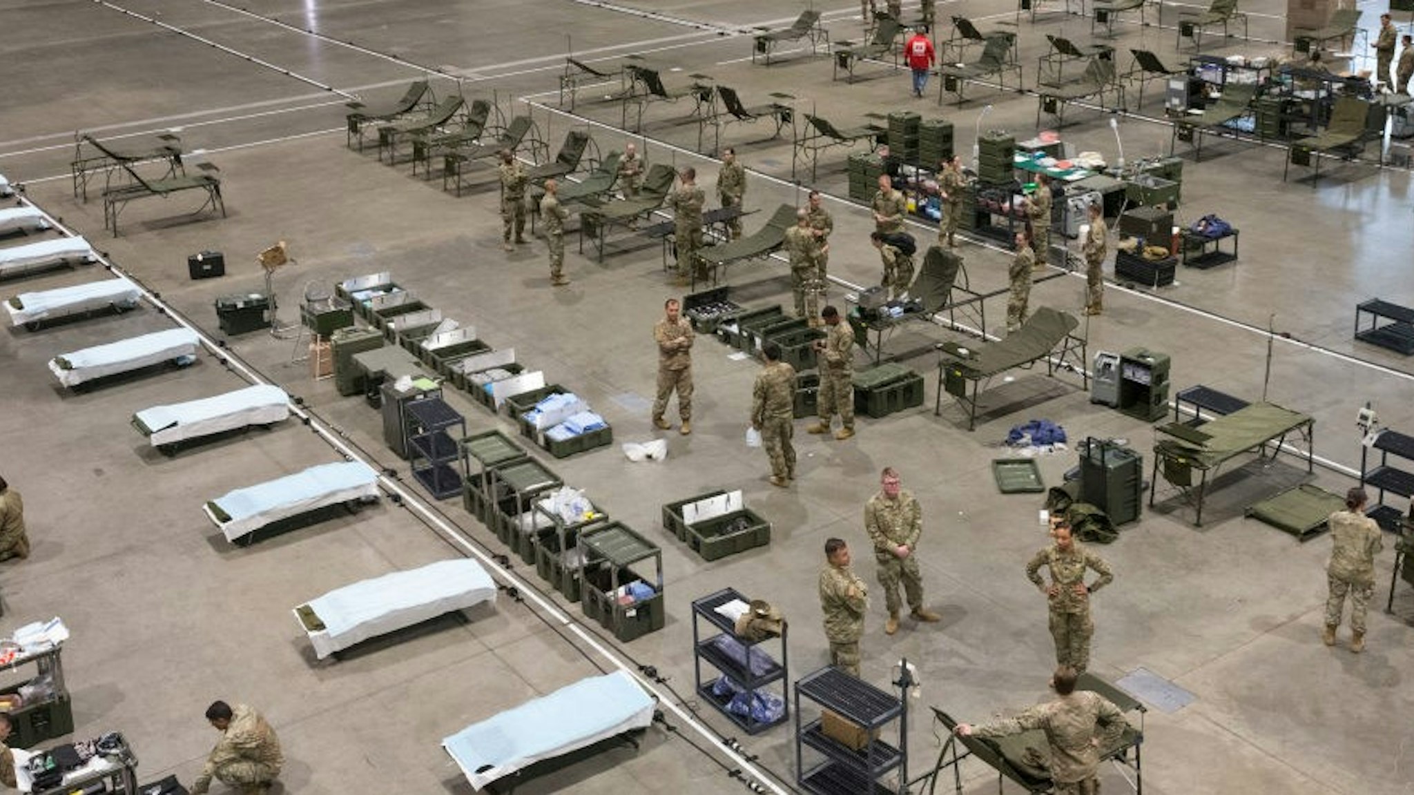 Military personnel set up the 627th Hospital Center field hospital at CenturyLink Event Center on March 31, 2020 in Seattle, Washington. 250 beds, including 148 from Fort Carson, Colorado, and other personnel from Joint Base Lewis-McChord, will be ready for non-COVID-19 patients sometime next week. When done it will have the capability of a normal hospital including an operating room, intensive care units, X-rays and more. (Photo by