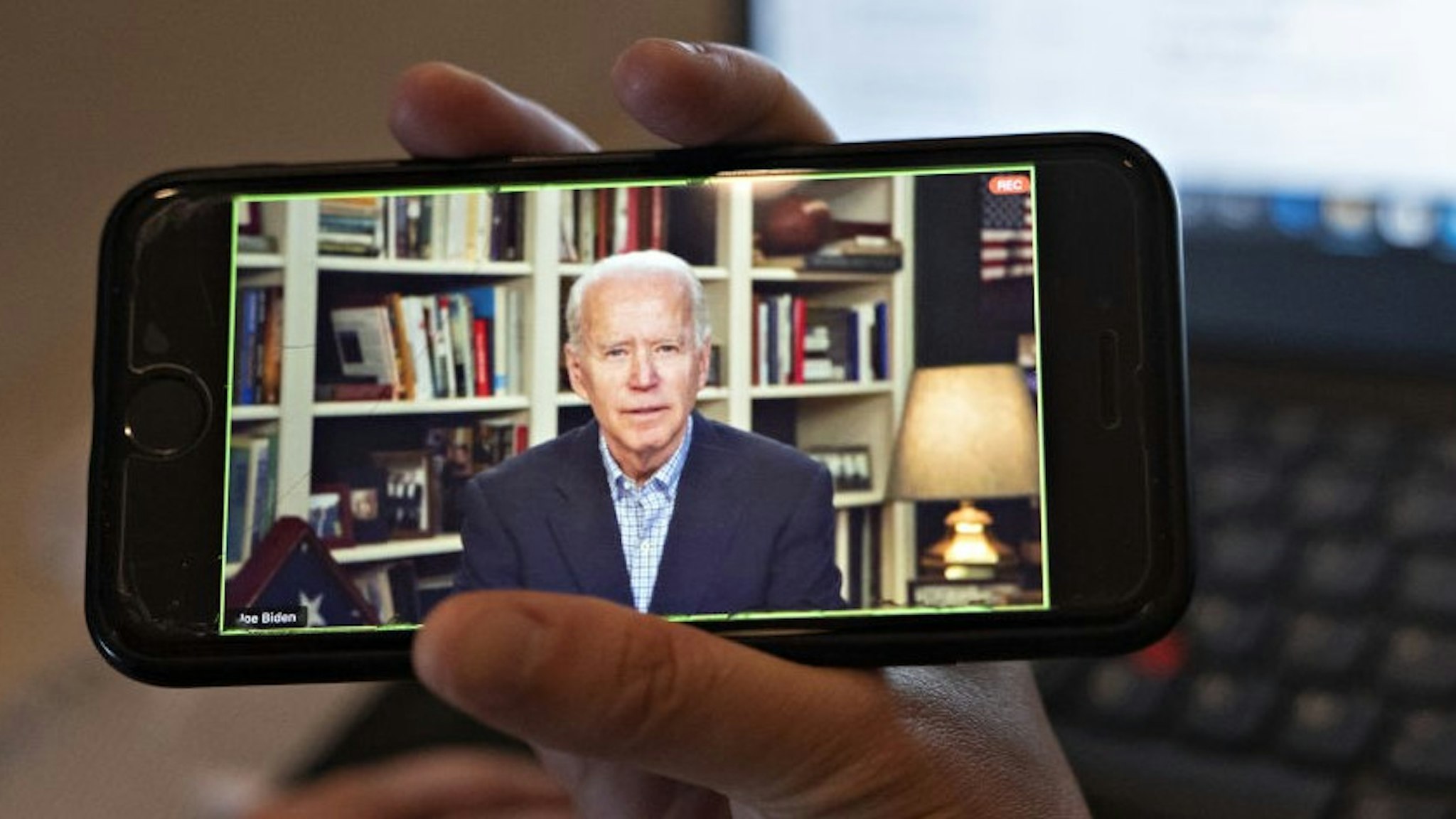 Former Vice President Joe Biden, 2020 Democratic presidential candidate, speaks during a virtual press briefing on a smartphone in this arranged photograph in Arlington, Virginia, U.S., on Wednesday, March 25, 2020. During the livestreamed news conference today, Biden said he didn't see the need for another debate, which the Democratic National Committee had previously said would happen sometime in April. Photographer: