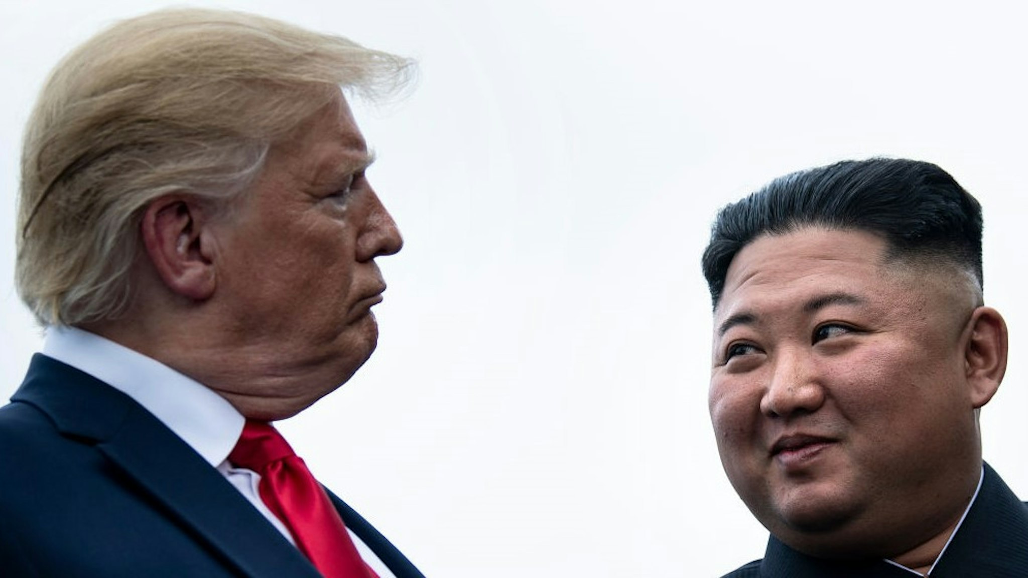 US President Donald Trump and North Korea's leader Kim Jong-un talk before a meeting in the Demilitarized Zone(DMZ) on June 30, 2019, in Panmunjom, Korea. (Photo by Brendan Smialowski / AFP) (Photo credit should read