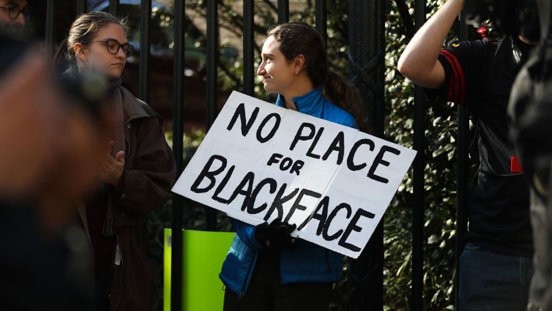 Protestors rally against Virginia Governor Ralph Northam outside of the governors mansion in downtown Richmond, Virginia on February 4, 2019. - Demonstrators are calling for the resignation of Virginia Governor Ralph Northam, after a photo of two people, one dressed as a Klu Klux Klan member and a person in blackface were discovered on his personal page of his college yearbook. Northam said that while he had not appeared in the photo, "many actions that we rightfully recognize as abhorrent today were commonplace" and he was not surprised such material made its way to the yearbook. (Photo by Logan Cyrus / AFP) (Photo credit should read