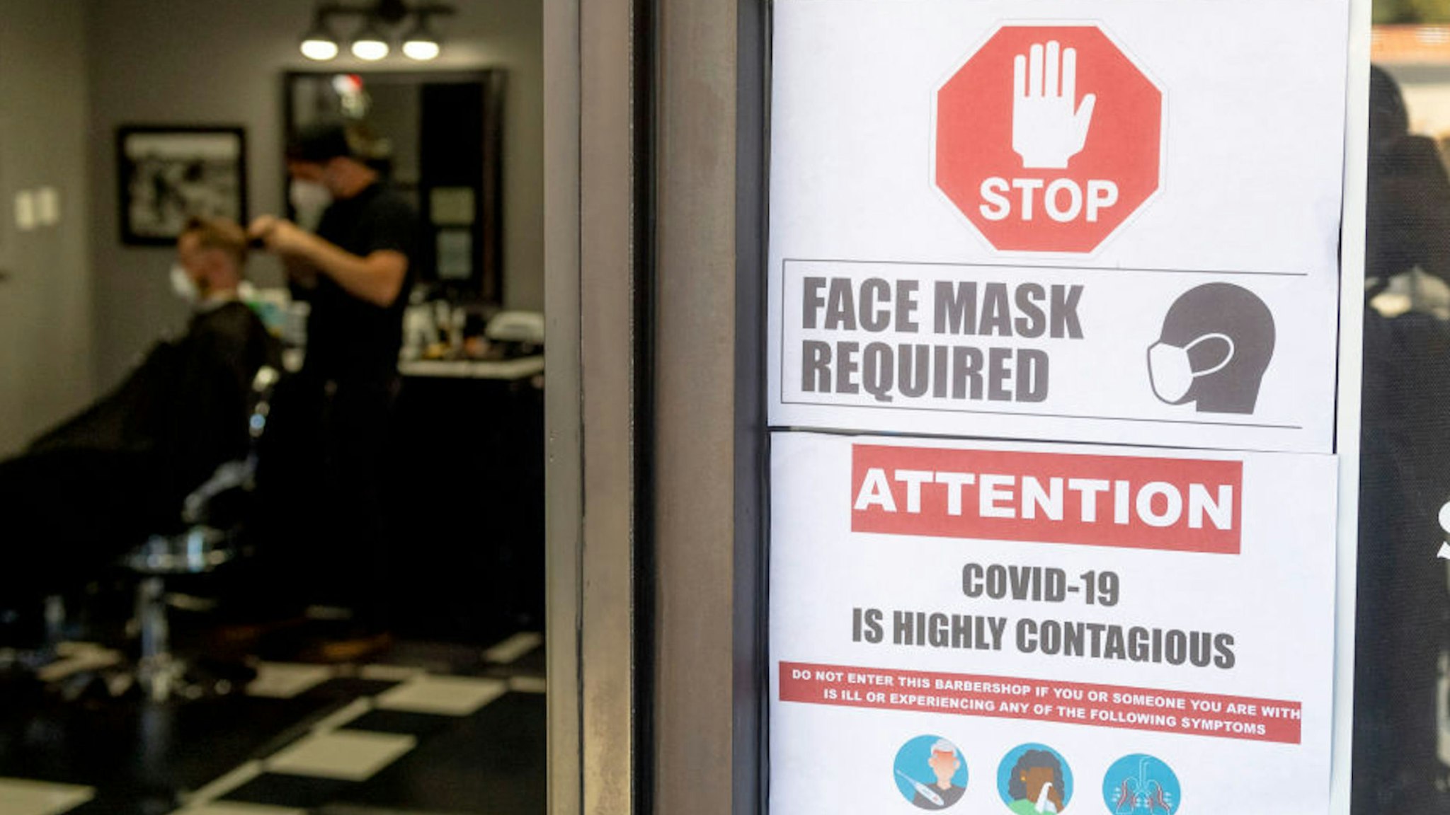 LAGUNA HILLS, CA - MAY 05: Customers maintain safety protocols at The BarberHood in Laguna Hills, CA, on Tuesday, May 5, 2020. The shop is one of the first to re-open and defy the state"u2019s stay-at-home order during the COVID-19 (coronavirus) lockdown.