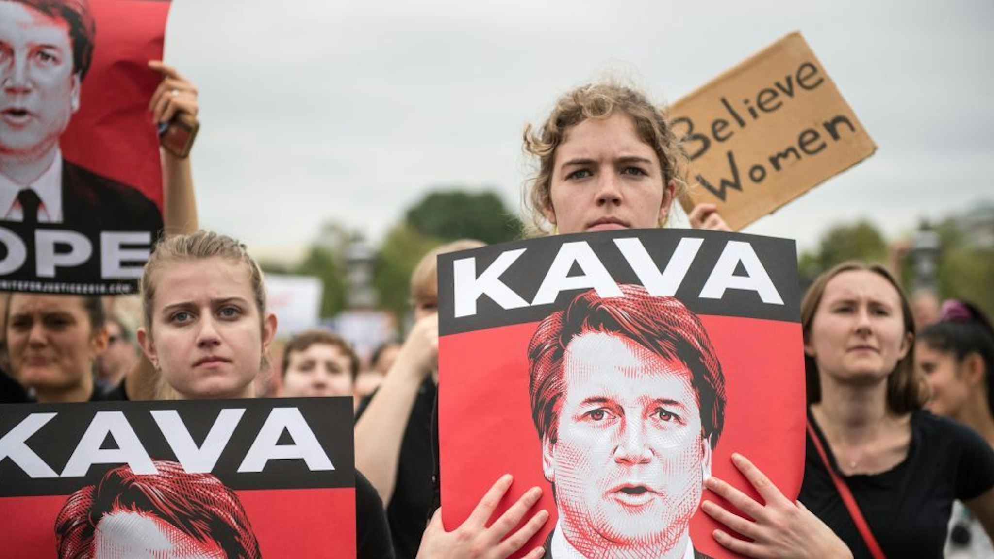 Women demonstrators protest against the appointment of Supreme Court nominee Brett Kavanaugh at the US Capitol in Washington DC, on October 6, 2018. - The US Senate confirmed conservative judge Kavanaugh as the next Supreme Court justice on October 6, offering US President Donald Trump a big political win and tilting the nation's high court decidedly to the right. (Photo by ROBERTO SCHMIDT / AFP)