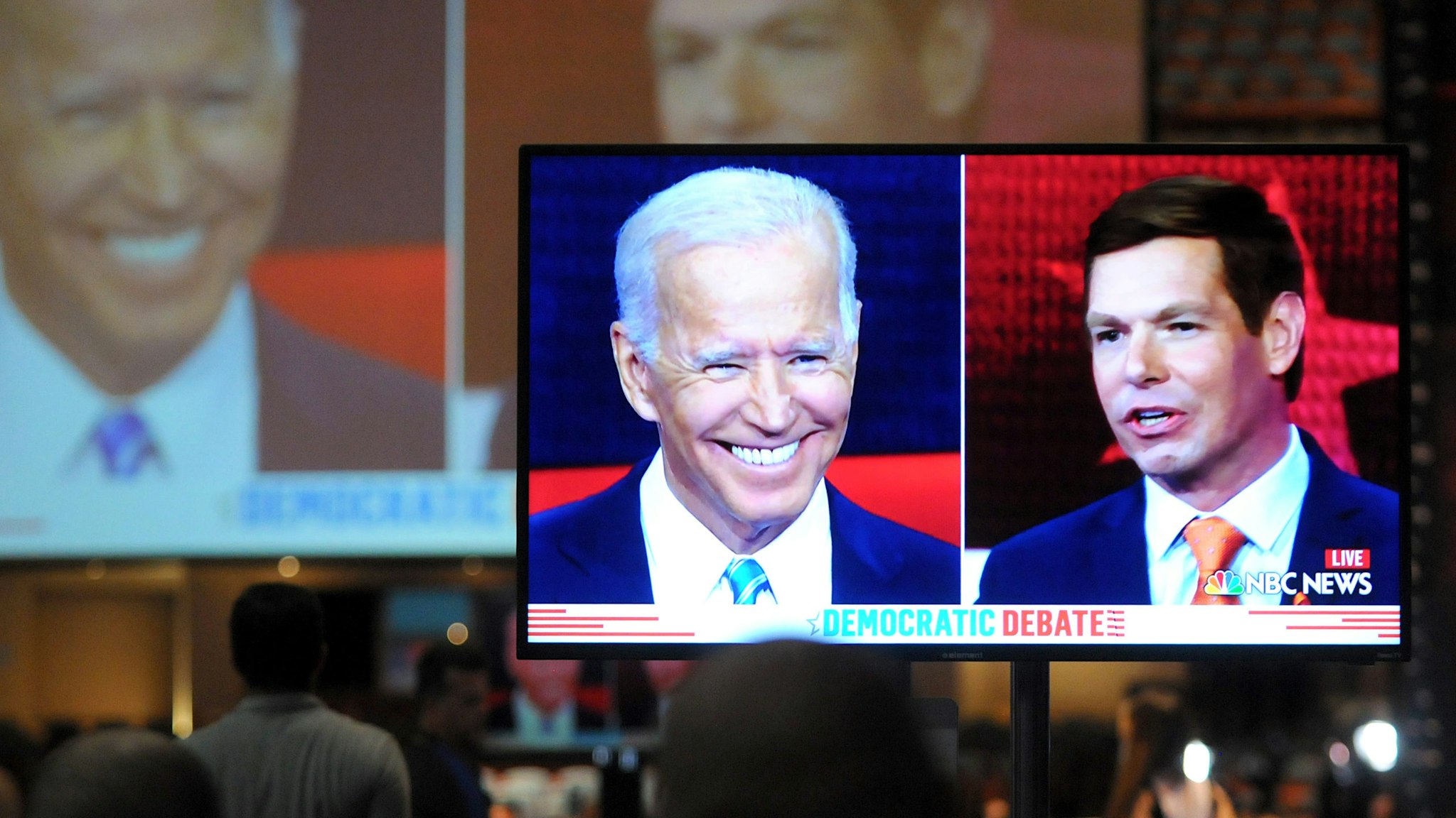 Democratic presidential hopeful Rep. Eric Swalwell of California is seen on a monitor in the spin room with former U.S. Vice President Joe Biden during night two of the first Democratic presidential primary debate for the 2020 election on June 27, 2019 at the Knight Concert Hall at the Adrienne Arsht Center for the Performing Arts in Miami, Florida.