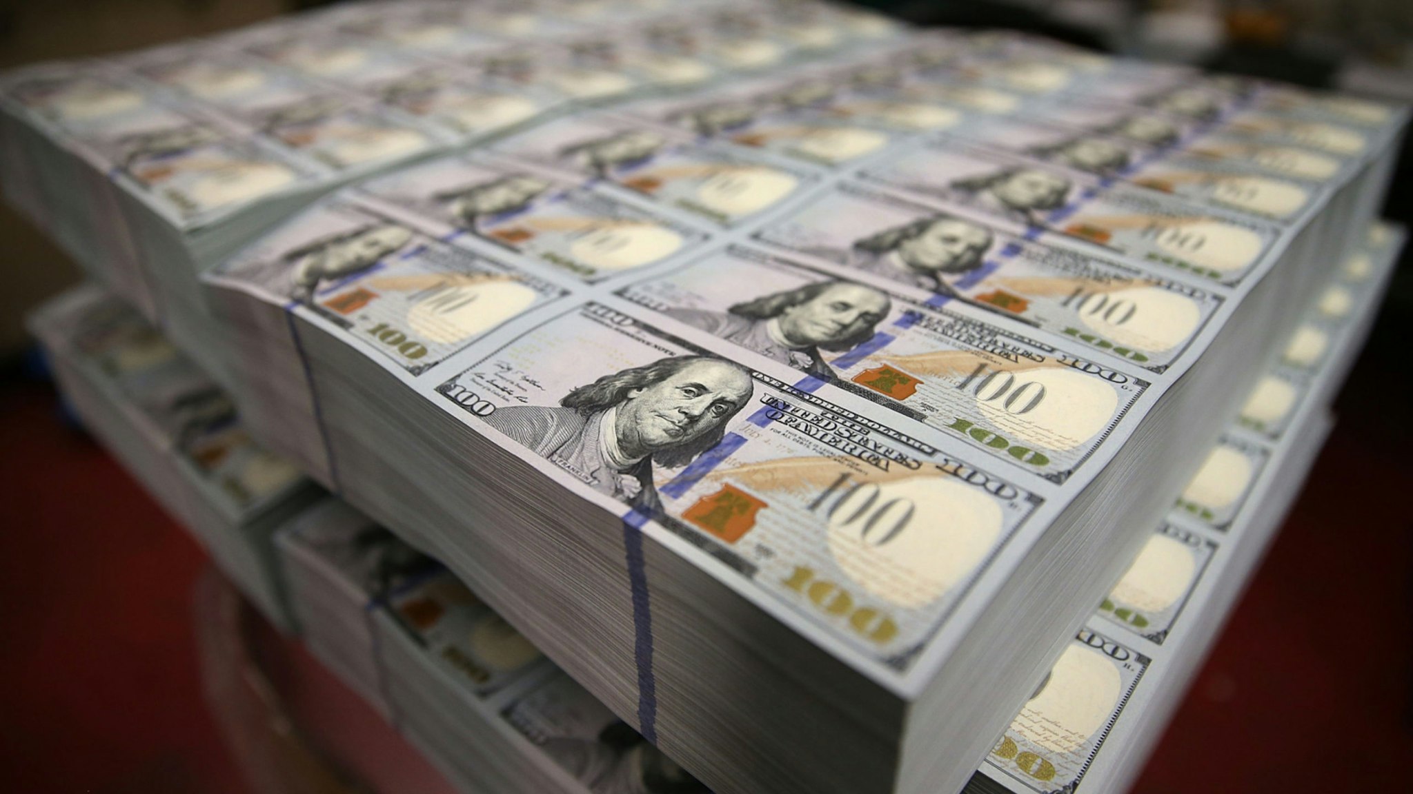Newly redesigned $100 notes lay in stacks at the Bureau of Engraving and Printing on May 20, 2013 in Washington, DC.