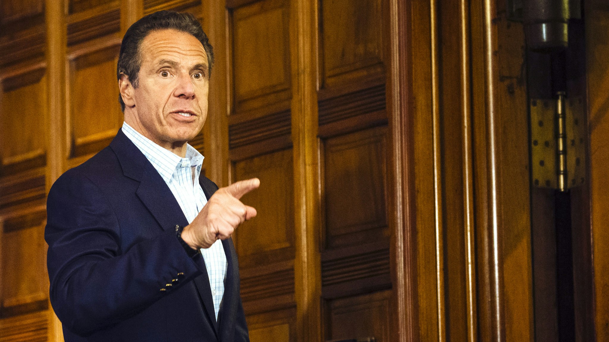 Andrew Cuomo, governor of New York, gestures as he leaves a news conference in the Red Room of the New York State Capitol Building in Albany, New York, U.S., on Sunday, May 17, 2020. Cuomo pleaded on Sunday for more New Yorkers to get tested for the coronavirus as the state reopens for business, engaging in a bit of political theater as he underwent a nasal swab test himself at his daily briefing
