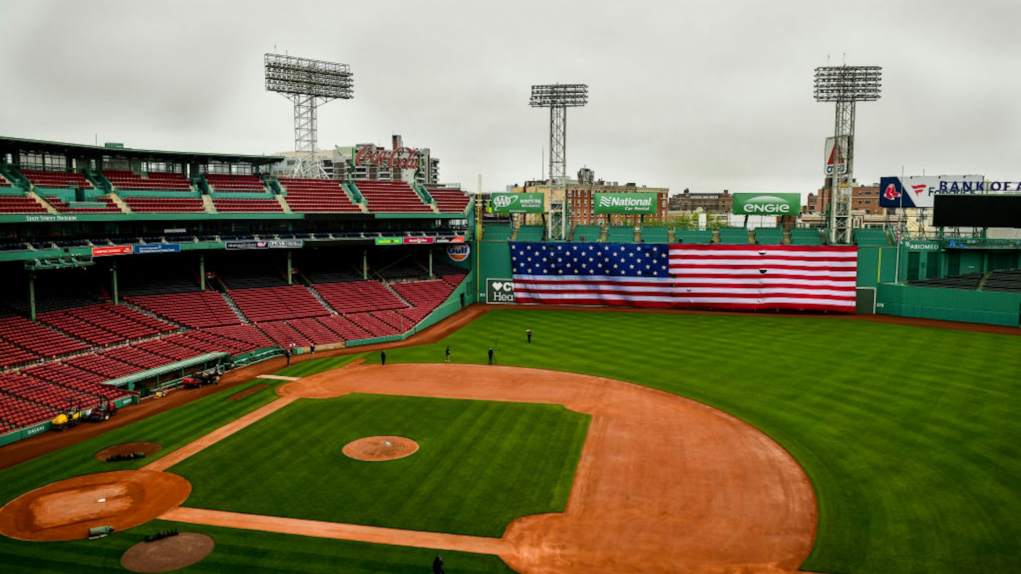 BOSTON, MA - MAY 25: The American flag is dropped over the Green Monster on Memorial Day as the Major League Baseball season is postponed due to the coronavirus pandemic on May 25, 2020 at Fenway Park in Boston, Massachusetts. (Photo by Billie Weiss/Boston Red Sox/Getty Images)