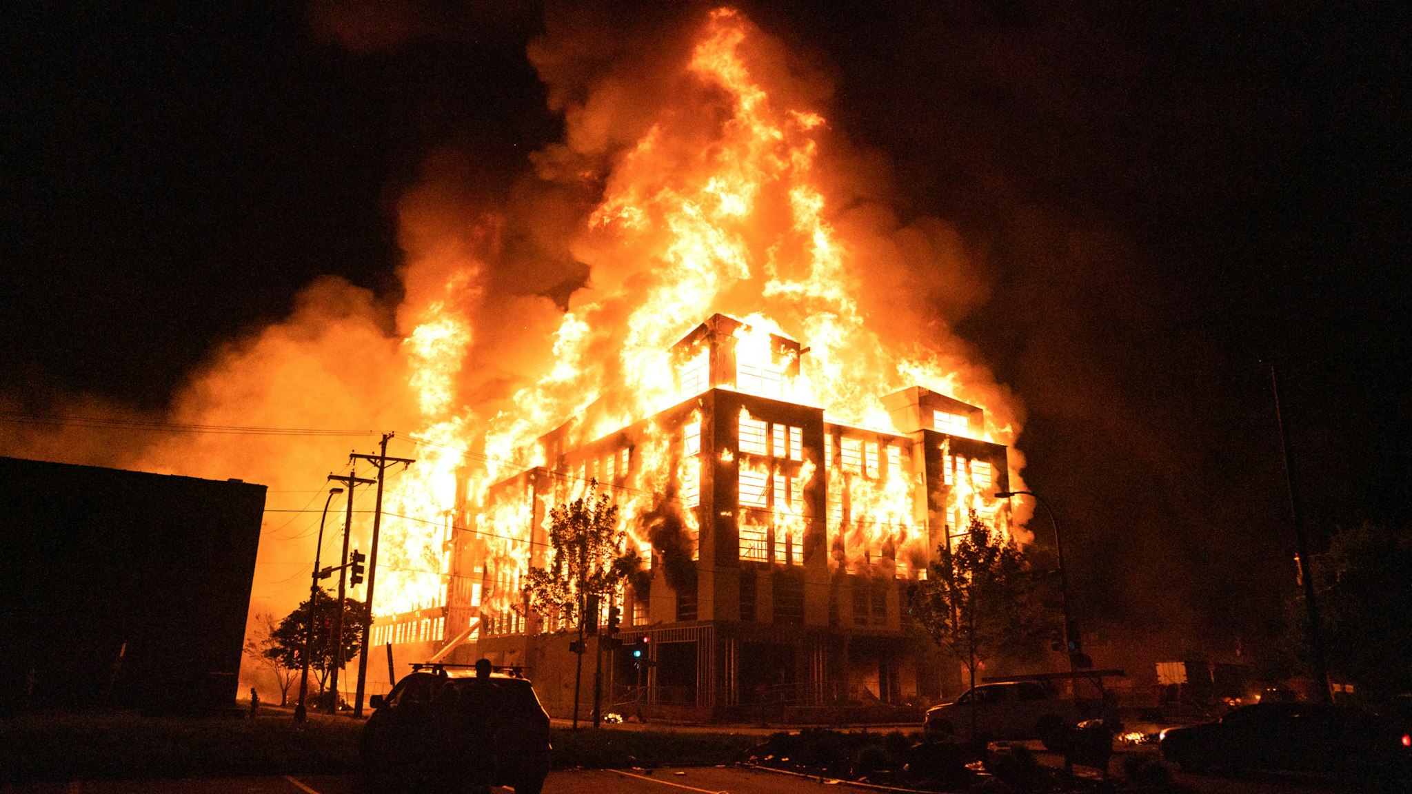 MINNEAPOLIS, MN - MAY 27: Rioters set fire to a multi-story affordable housing complex under construction near the Third Precinct, spreading the blaze to surrounding homes. Protester and police clashed violently in South Minneapolis as looters attacked business on Lake Street on Wednesday, May 27, 2020 in Minneapolis. The protests were sparked by the death of George Floyd at the hands of a Minneapolis Police officer Monday.