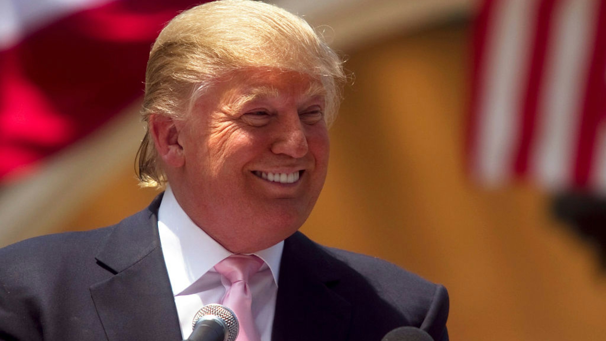Billionaire Donald Trump laughs while speaking to a crowd at the 2011 Palm Beach County Tax Day Tea Party on April 16, 2011 at Sanborn Square in Boca Raton, Florida.