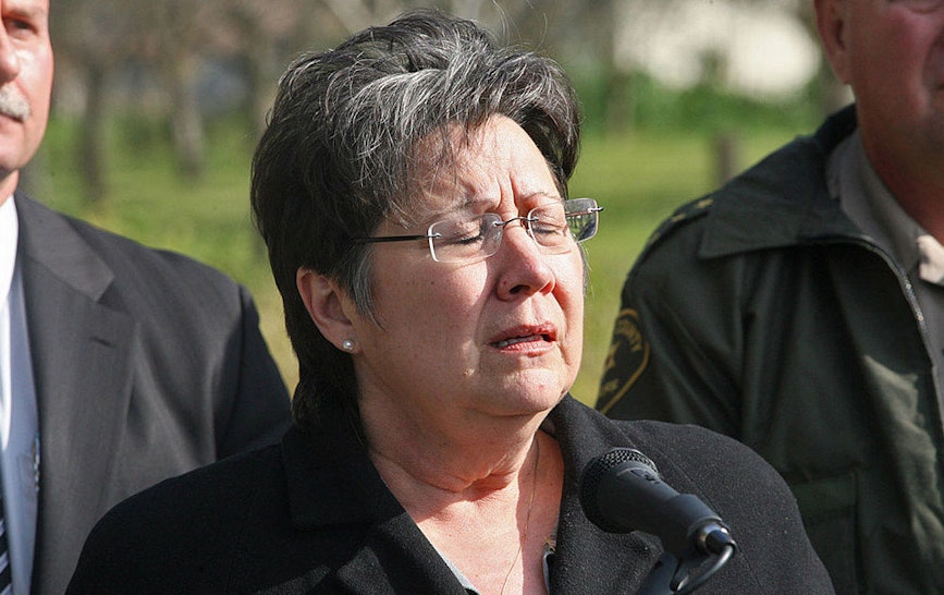 Fresno County Sheriff Margaret Mims (middle) closes her eyes during an emotional news conference concerning an ongoing standoff near Minkler, California, on Thursday, February 25, 2010.