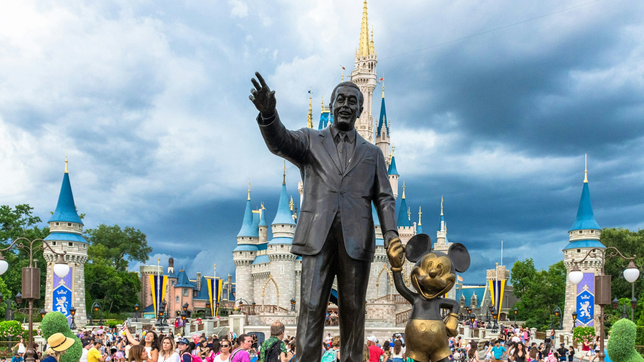 ORLANDO, FLORIDA, UNITED STATES - 2019/07/17: Walt Disney and Mickey Mouse statue inside of the Magic Kingdom theme park . The Cinderella castle can be seen in the background. (Photo by Roberto Machado Noa/LightRocket via Getty Images)