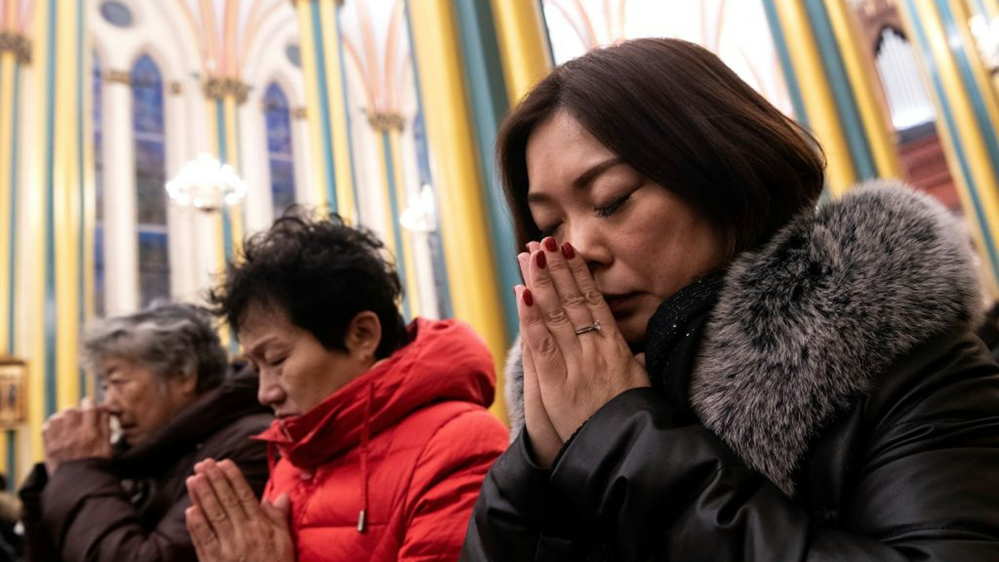 Worshippers attend a Christmas eve mass at the Xishiku Cathedral in Beijing on December 24, 2019.