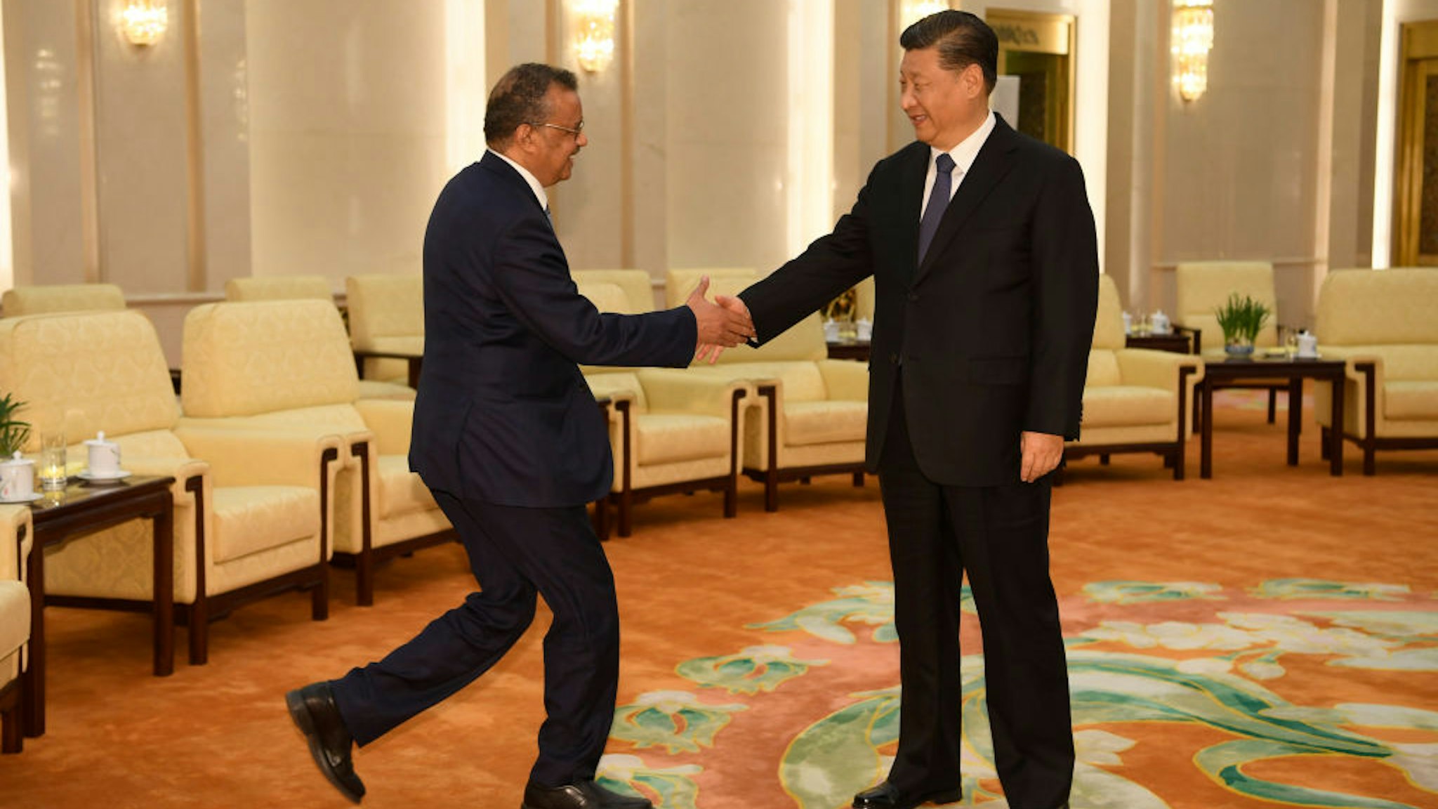 World Health Organization director general Tedros Adhanom (L) shakes hands with Chinese President Xi jinping before a meeting at the Great Hall of the People in Beijing on January 28, 2020. -