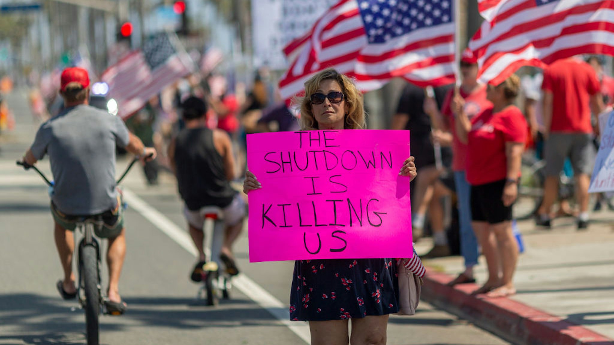 Protesters call to reopen businesses and beaches as the growing the coronavirus pandemic continues to cripple the economy on May 1, 2020 in Huntington Beach, California.