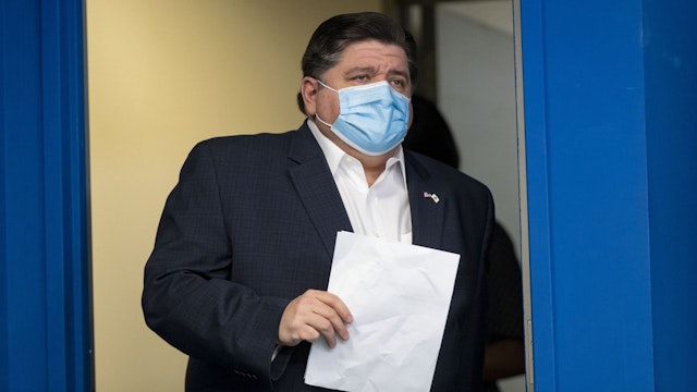 Illinois Gov. J.B. Pritzker arrives in a mask to speak April 19, 2020, at the Thompson Center during the coronavirus pandemic. (Brian Cassella/Chicago Tribune/Tribune News Service via Getty Images)