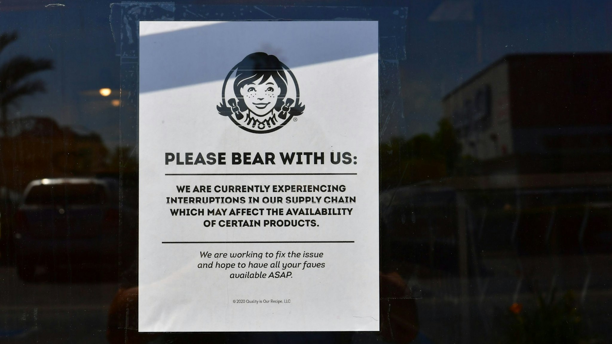 A sign posted on a walk-in entrance to a Wendy's fast food restaurant in Alhambra, California on May 5, 2020. - A sign displayed on the walk-in entrance mentions an interruption in supply chain affecting availability of certain products. Wendy's, an international chain restaurant famous for the 1984 catchphrase "Where's the Beef?" is experiencing a beef shortage caused by the coronavirus pandemic, as some restaurants stop serving burgers. (Photo by Frederic J. BROWN / AFP) (Photo by FREDERIC J. BROWN/AFP via Getty Images)