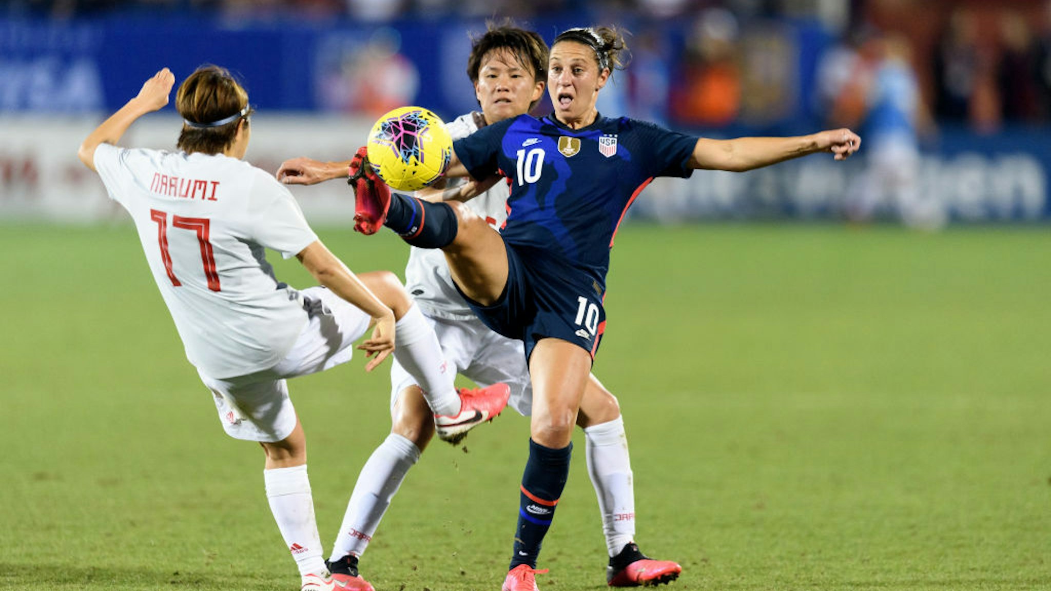 Carli Lloyd #10 of the United States reaches out to gain control of a loose ball with Moeka Minami #5 and Narumi Miura #17 of Japan on either side of her during a game between Japan and USWNT at Toyota Stadium on March 11, 2020 in Frisco, Texas.
