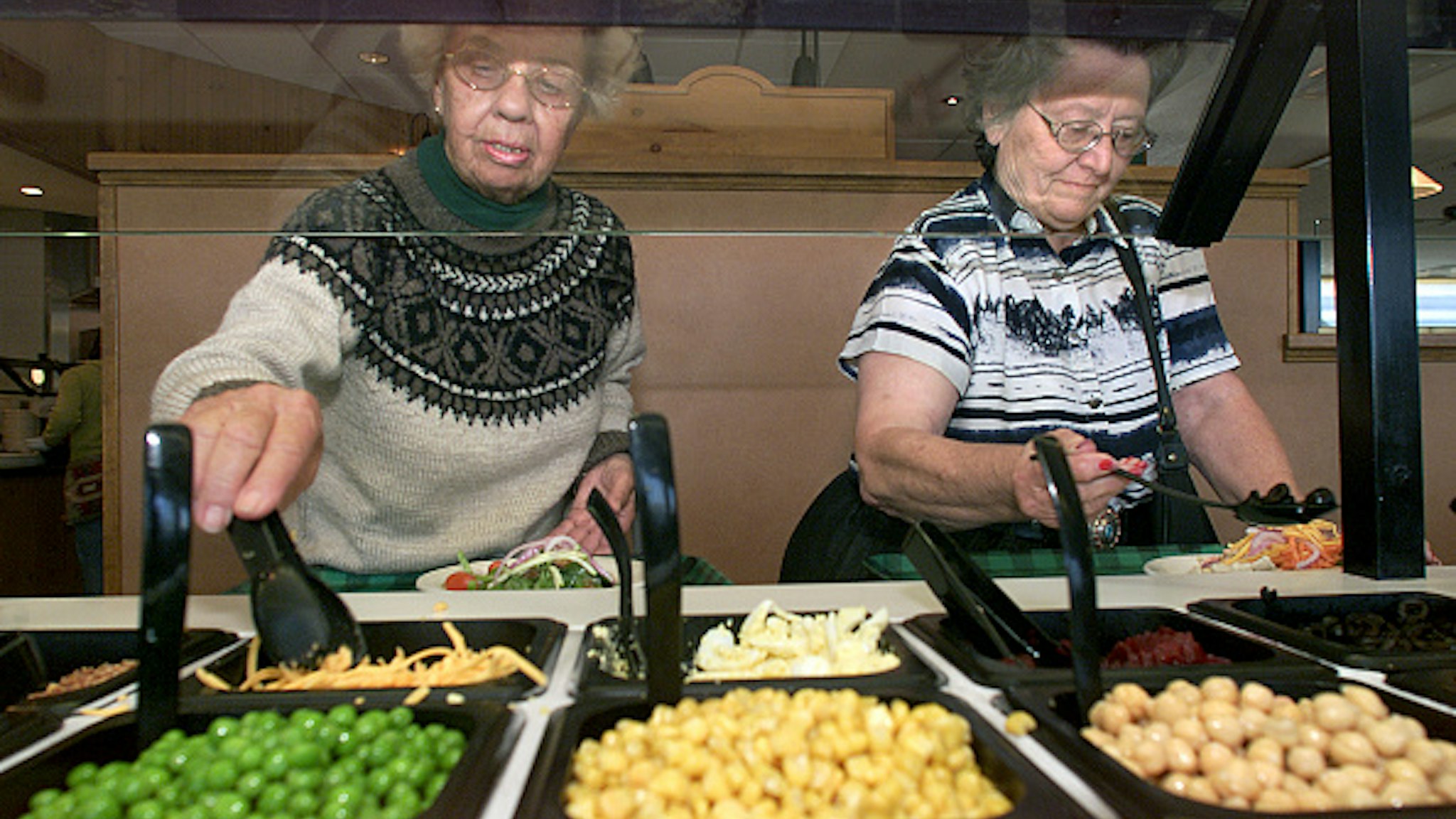 June Ross, left, from Lancaster, and friend Barbara Murray, from Victorville, fill their plates up while visiting the salad bar at Souplantation in Camarillo. Digital image taken on 05/09/03