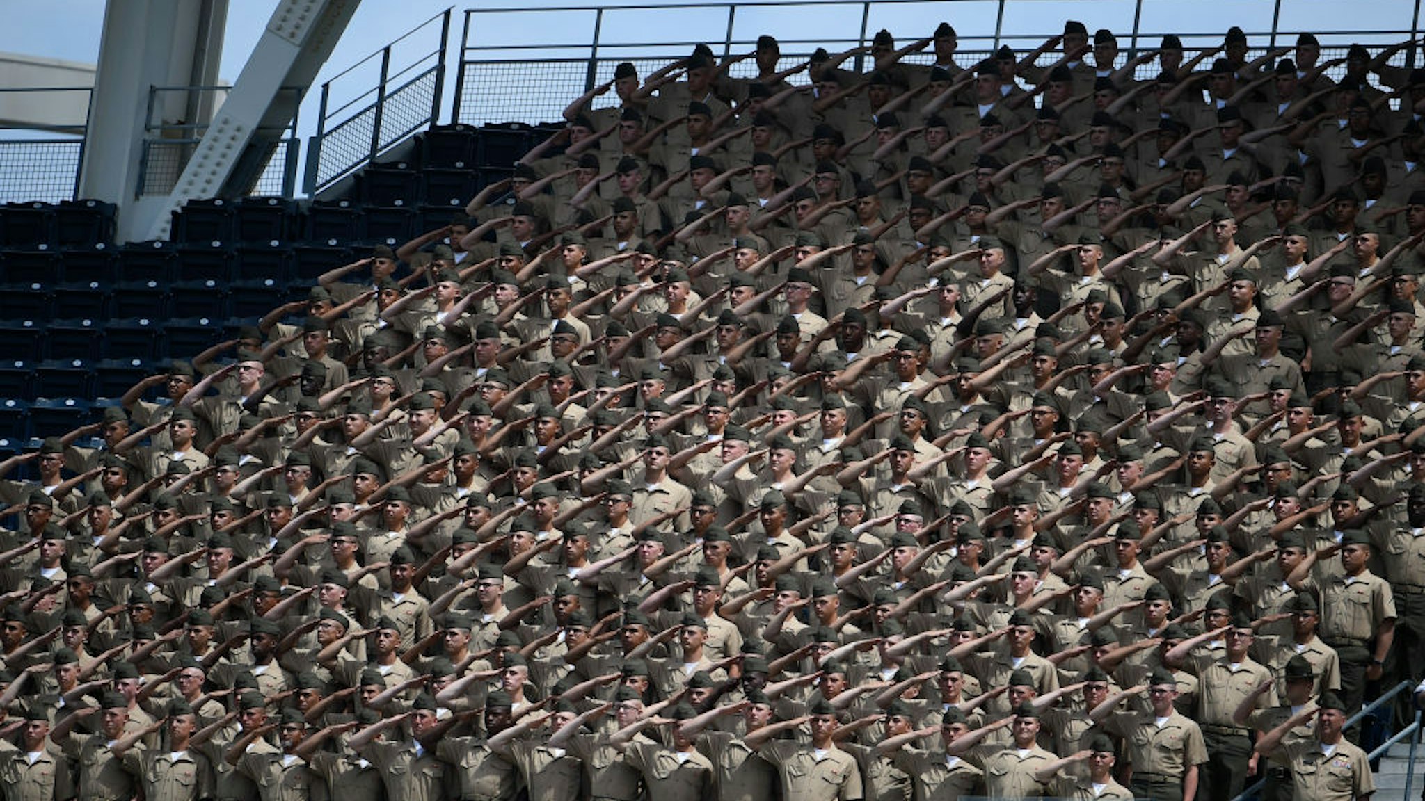 U.S. Marine Corps recruits salute before a baseball game between San Francisco Giants and San Diego Padres at PETCO Park as part of Military Opening Day on April 9, 2017 in San Diego, California.