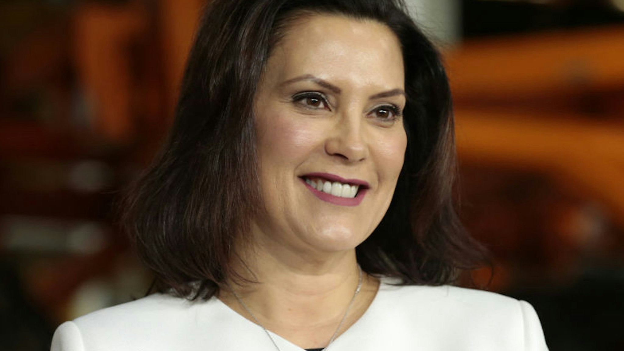 Gretchen Whitmer, governor of Michigan, smiles during an event at the General Motors Co. Orion Assembly plant in Orion Township, Michigan, U.S., on Friday, March 22, 2019. General Motors Co. committed to investing $1.8 billion at plants in six states and to creating 700 new jobs, as the largest U.S. automaker looks to ward off months of criticism by President Donald Trump