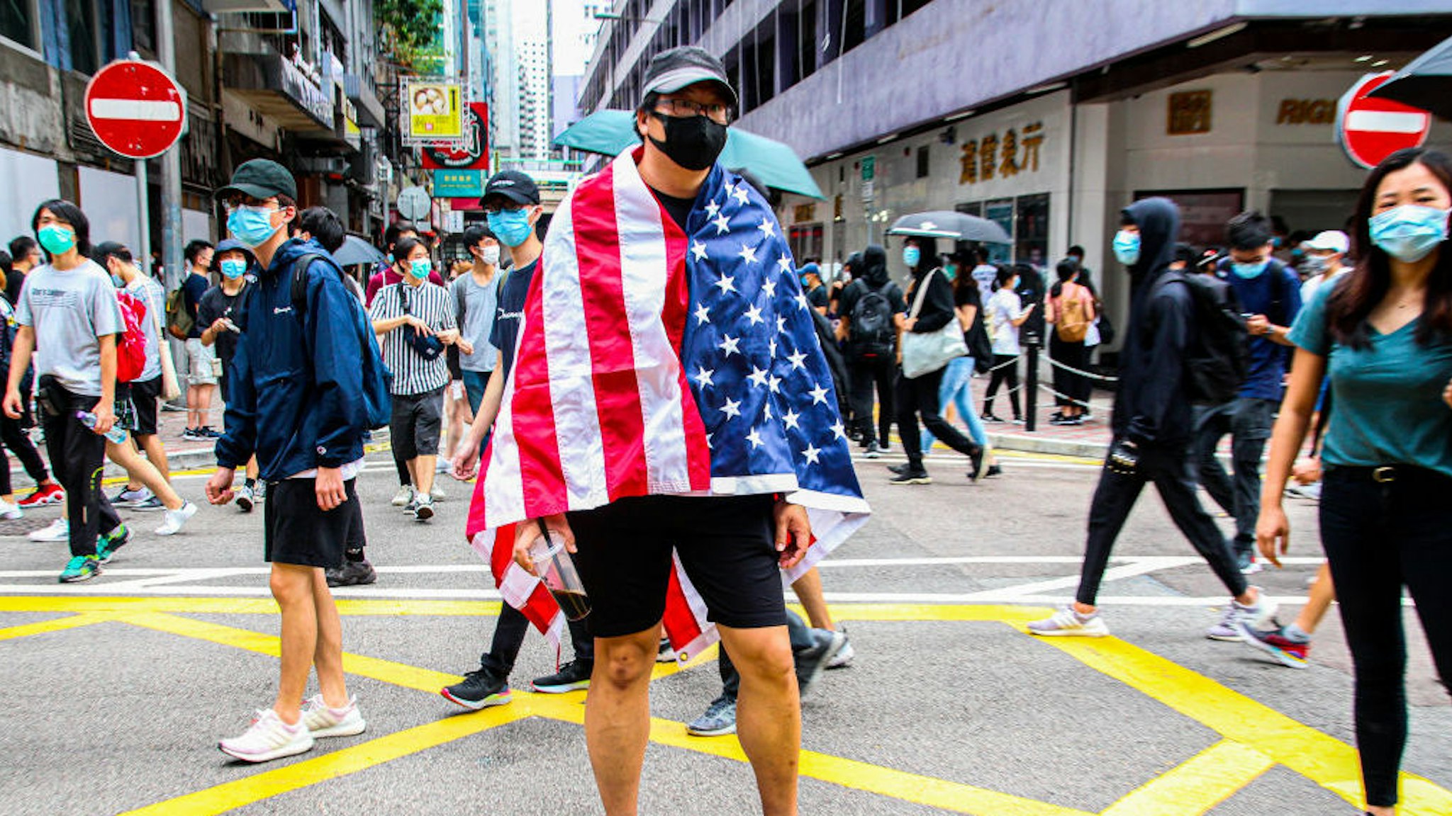 One Hong Kong street protester is draped with the United States of America flag during the 24th May protests in the Causeway Bay district in Hong Kong, China, on Sunday, May 24, 2020. (Photo by Tommy Walker/NurPhoto via Getty Images)