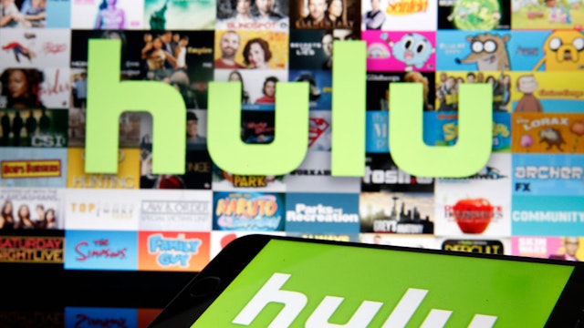 In this photo illustration, the Hulu media service provider's logo is displayed on the screen of an iPhone in front of the screen of a television showing the Hulu logo on March 28, 2020 in Paris, France. As the Coronavirus moves to the U.S., Disney has announced that it will provide a free 24/7 ABC news feed to Hulu Live to On-Demand subscribers. (Photo Illustration by Chesnot/Getty Images)