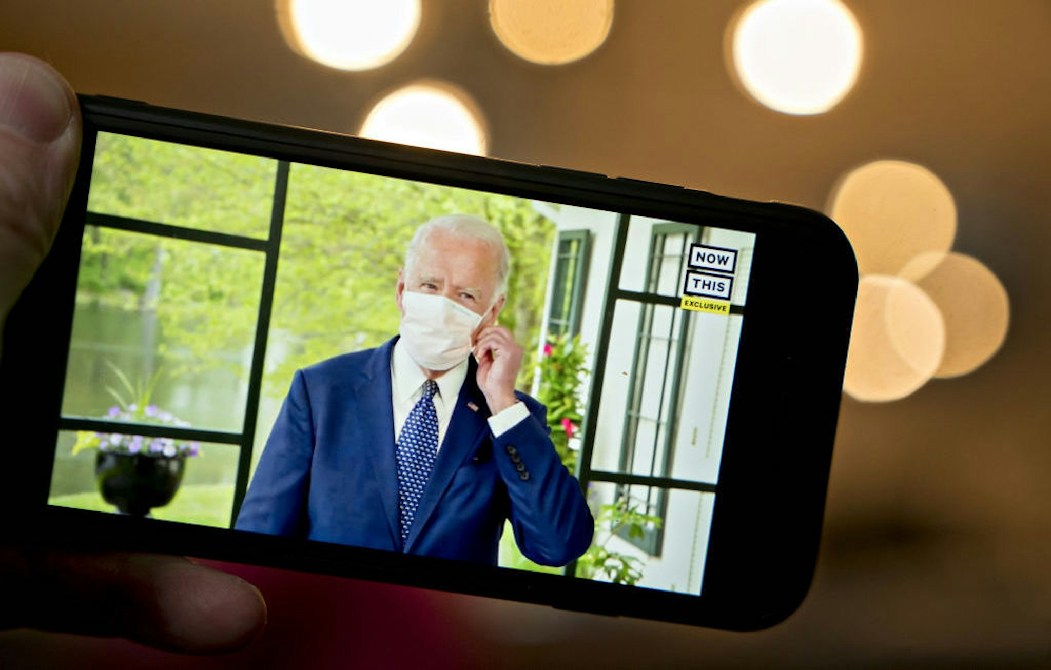 Former Vice President Joe Biden, presumptive Democratic presidential nominee, wears a protective mask during a NowThis economic address seen on a smartphone in Arlington, Virginia, U.S., on Friday, May 8, 2020. A super political action committee backing Joe Biden will launch a $10 million television ad campaign touting the presumptive Democratic nominee's leadership on the economic recovery after the 2008 financial crisis. Photographer: Andrew Harrer/Bloomberg