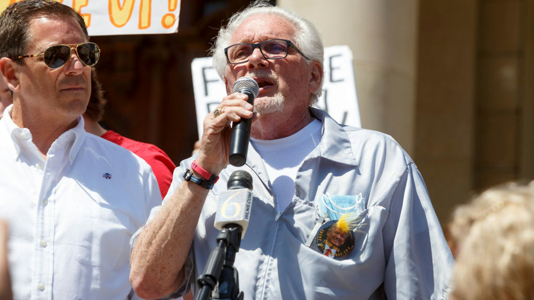 LANSING, MI - MAY 20: Owosso barber, Karl Manke, gives a speech before cutting hair for free on the steps of the state Capitol during Operation Haircut on May 20, 2020 in Lansing, Michigan. The event was a protest planned by the Michigan Conservative Coalition in response to an Owosso barber, Karl Manke, whose business license was taken away after he violated the stay-at-home order by reopening. The protest is part of a growing national movement against stay-at-home orders that are designed to help slow the spread of the coronavirus (COVID-19). (Photo by Elaine Cromie/Getty Images)