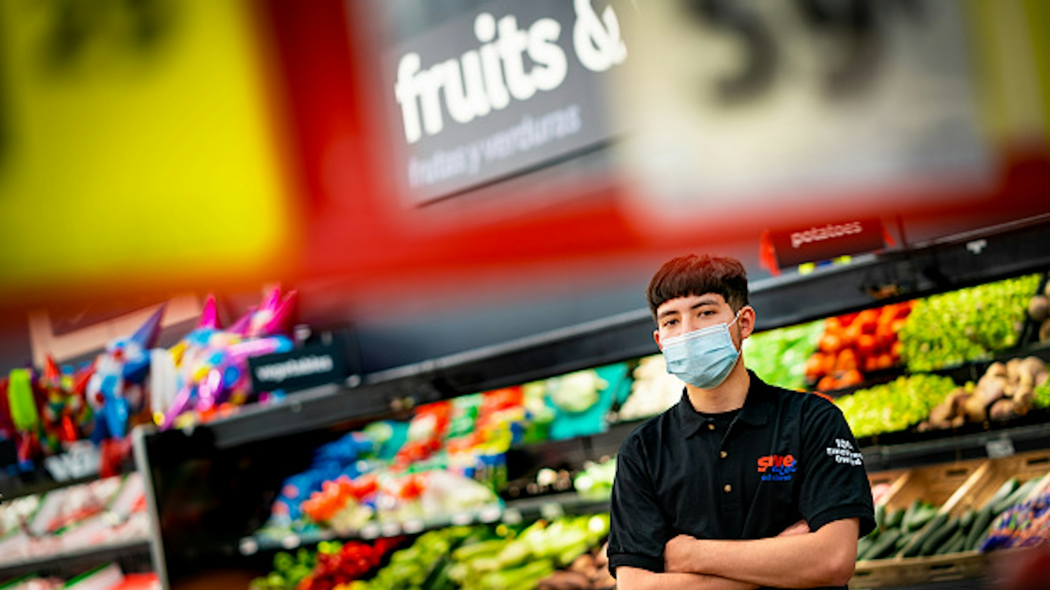 DENVER, CO - MAY, 13: Jael Marquez, 17, poses for a portrait inside the Save-A-Lot grocery store on May 13th in Denver, Colorado. Marquez works as a produce clerk at Save-A-Lot and has been working as an essential worker during the coronavirus pandemic.