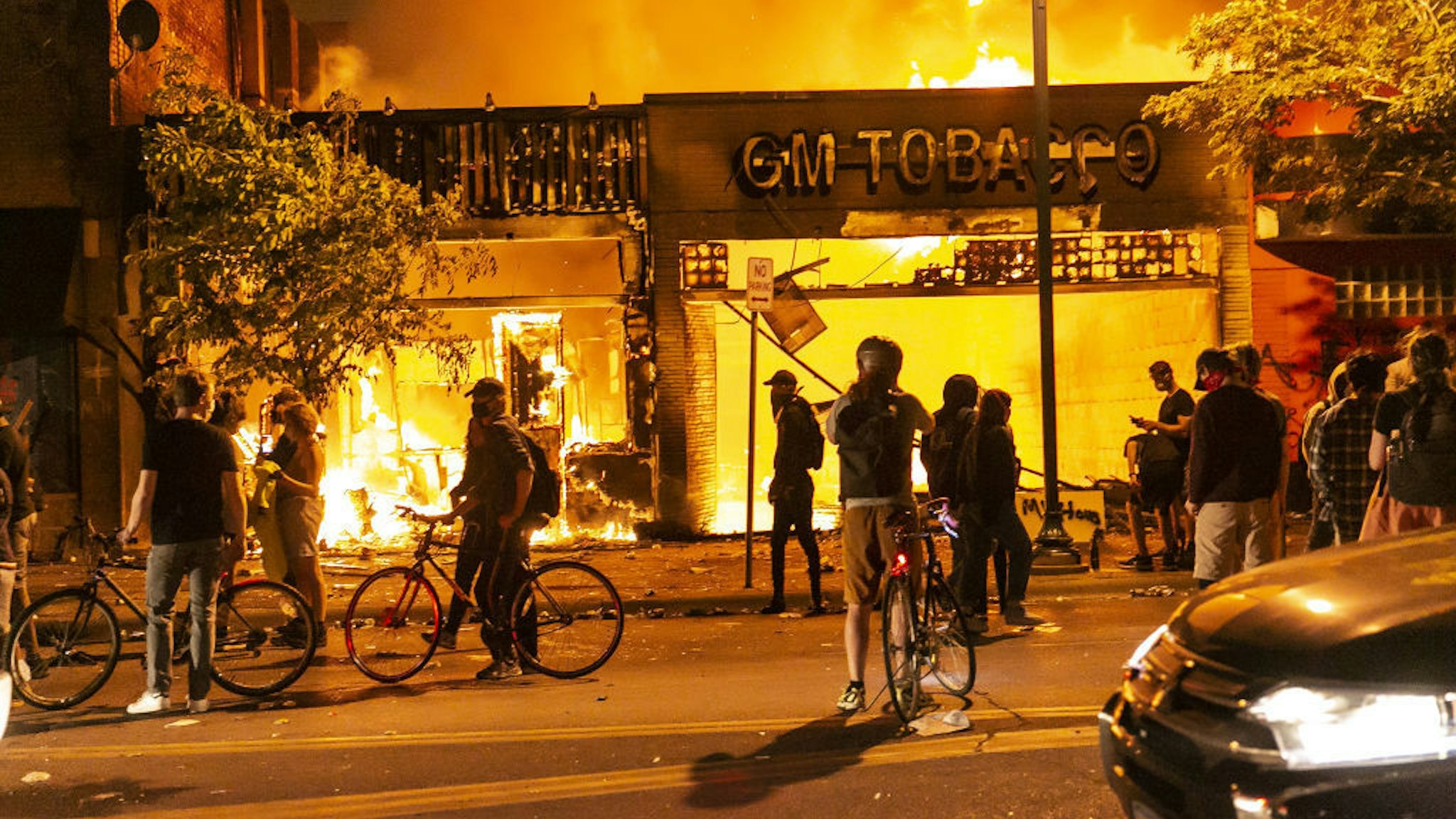 Protestors set a shop on fire on Thursday, May 28, 2020, during the third day of protests over the death of George Floyd in Minneapolis. Floyd died in police custody in Minneapolis on Monday night, after an officer held his knee into Floyd's neck for more than 5 minutes. (Photo by Jordan Strowder/Anadolu Agency via Getty Images)