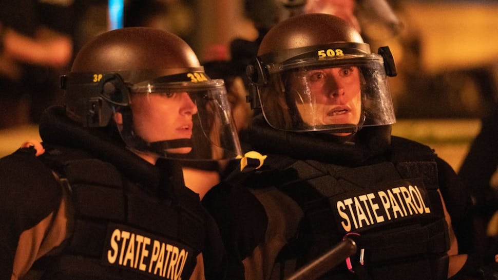 Minneapolis, MN May 27: Minnesota State Patrol officers stood watch outside of the Third Precinct. Protester and police clashed violently in South Minneapolis as looters attacked business on Lake Street on Thursday, May 28, 2020 in Minneapolis. The protests were sparked by the death of George Floyd at the hands of a Minneapolis Police officer Monday.