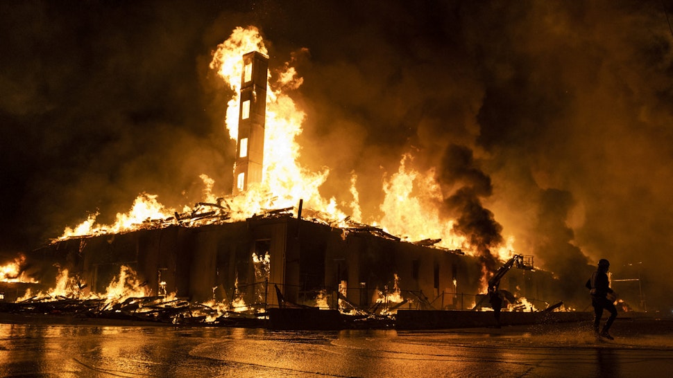 MINNEAPOLIS, MN - MAY 27: A construction site burns in a large fire near the Third Police Precinct on May 27, 2020 in Minneapolis, Minnesota. A number of businesses and homes were damaged as the area has become the site of an ongoing protest after the police killing of George Floyd. Four Minneapolis police officers have been fired after a video taken by a bystander was posted on social media showing Floyd's neck being pinned to the ground by an officer as he repeatedly said, I can’t breathe. Floyd was later pronounced dead while in police custody after being transported to Hennepin County Medical Center.'s neck being pinned to the ground by an officer as he repeatedly said, I can’t breathe. Floyd was later pronounced dead while in police custody after being transported to Hennepin County Medical Center.