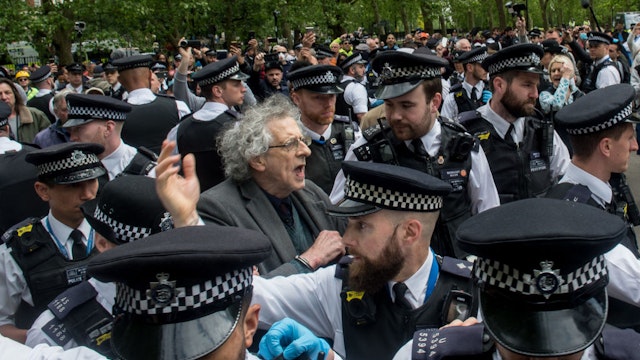 LONDON, ENGLAND - MAY 16: Piers Corbyn (brother of former Labour leader Jeremy Corbyn) is arrested as conspiracy theorists gather at Hyde Park Corner to defy the emergency legislation and protest their claim that the Coronavirus pandemic is part of a secret conspiracy on May 16, 2020 in London, United Kingdom. The prime minister has announced the general contours of a phased exit from the current lockdown, adopted nearly two months ago in an effort curb the spread of Covid-19.