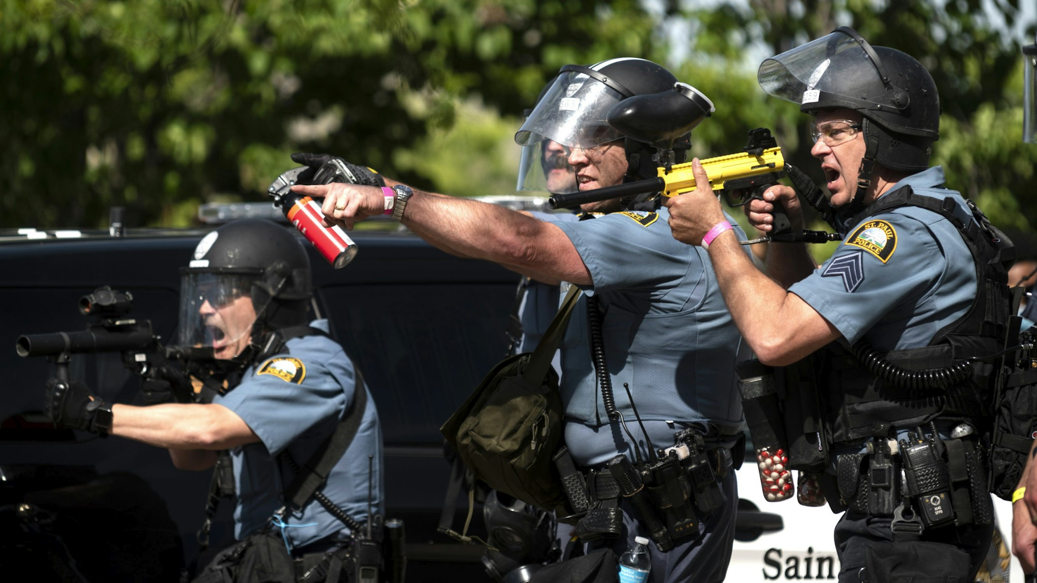 ST. PAUL, MN - MAY 28: Police aim their weapons at protesters in the parking lot of a Target store on May 28, 2020 in St. Paul, Minnesota. Police and protesters continued to clash for a third night after George Floyd was killed in police custody on Monday.