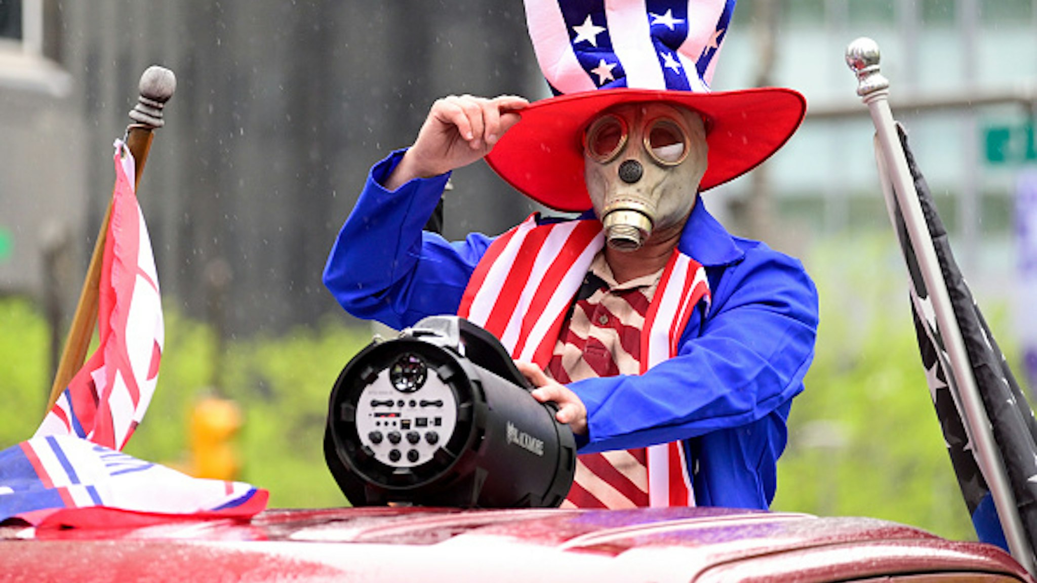 Robert McMaster, of Bridesburg stands on the bed of a pick-up while wearing a mask as he participates in a Reopen protest, at City Hall in Philadelphia, PA; on May 8, 2020. Protestors gather to demand reopening of the state during a rally. This week Governor Tom Wolf extends Stay-at-home order for the region.