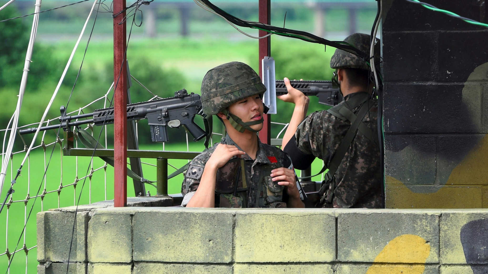 South Korean soldiers stand guard at a guard post near the Demilitarized Zone (DMZ) dividing two Koreas in the border city of Paju on August 11, 2017. As nuclear-armed North Korea's missile stand-off with the US escalates, calls are mounting in the South for Seoul to build nuclear weapons of its own to defend itself -- which would complicate the situation even further.