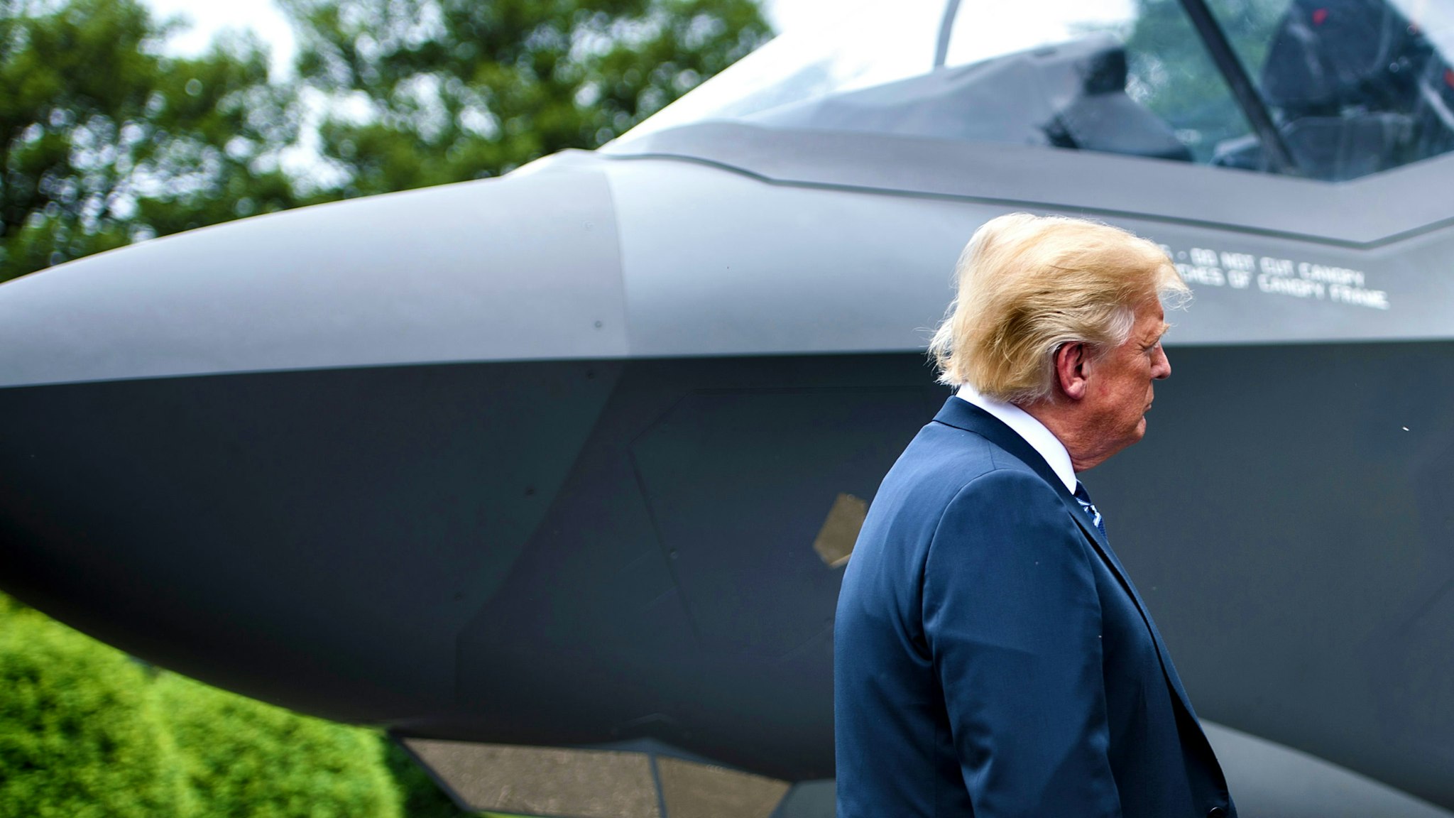 US President Donald Trump stands with an F-35 on the South Lawn of the White House during an event to showcase American made products at the White House July 23, 2018 in Washington, DC.