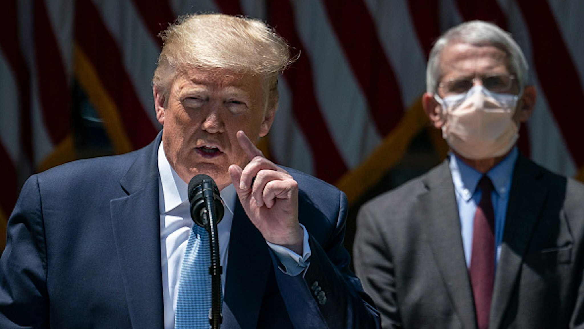 WASHINGTON, DC - MAY 15: Dr. Anthony Fauci (R), director of the National Institute of Allergy and Infectious Diseases, looks on as U.S. President Donald Trump delivers remarks about coronavirus vaccine development in the Rose Garden of the White House on May 15, 2020 in Washington, DC. Dubbed "Operation Warp Speed," the Trump administration is announcing plans for an all-out effort to produce and distribute a coronavirus vaccine by the end of 2020.