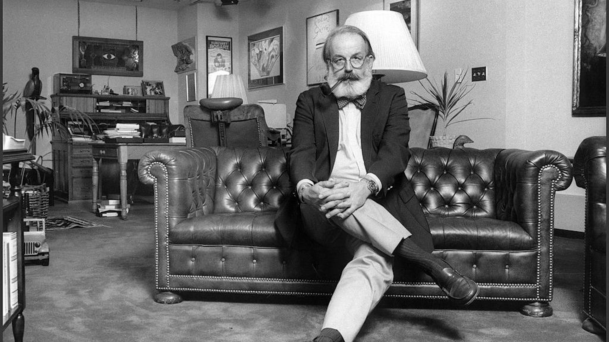 Portrait of Van Gordon Sauter, former president of CBS News, seated in his CBS office, New York, 1985. He is smoking a pipe and wears a bow-tie. (Photo by Oliver Morris/Getty Images)