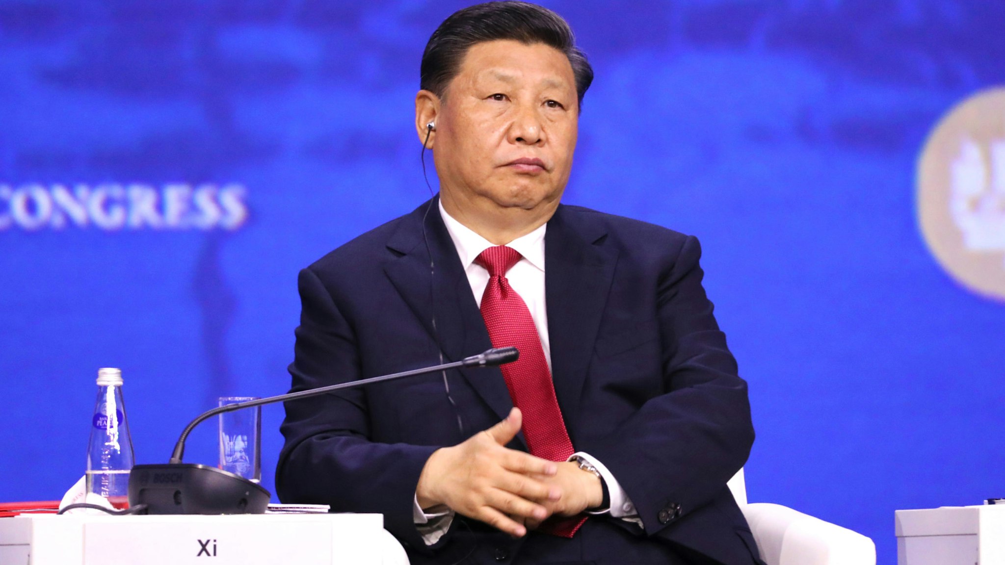 Xi Jinping, China's president, listens to a translation of a speech through an earpiece during the plenary session at the St. Petersburg International Economic Forum (SPIEF) in St. Petersburg, Russia, on Friday, June 7, 2019. Over the last 21 years, the Forum has become a leading global platform for members of the business community to meet and discuss the key economic issues facing Russia, emerging markets, and the world as a whole.