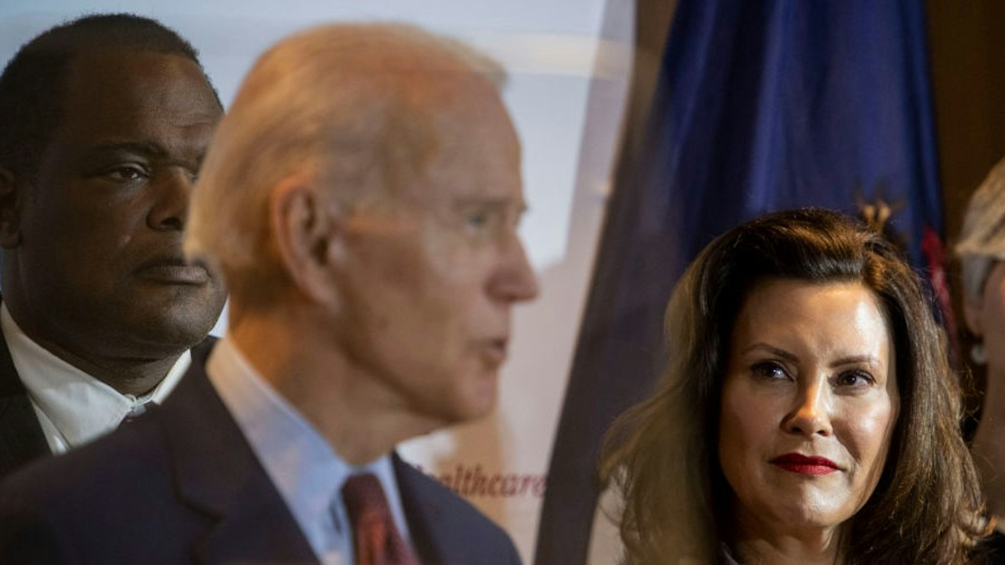 Former Vice President Joe Biden speaks as Michigan Governor Gretchen Whitmer looks on at an event at Cherry Health in Grand Rapids, MI on March 9, 2020. (Photo by